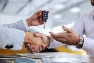 Line of used vehicles outside a dealership