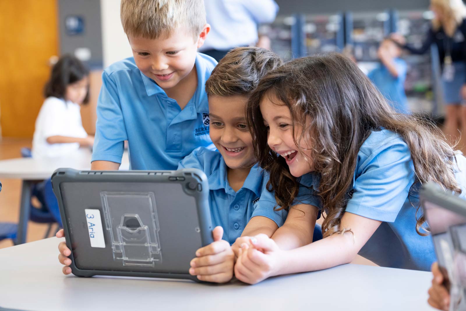 Three Lower Division students interacting on an iPad