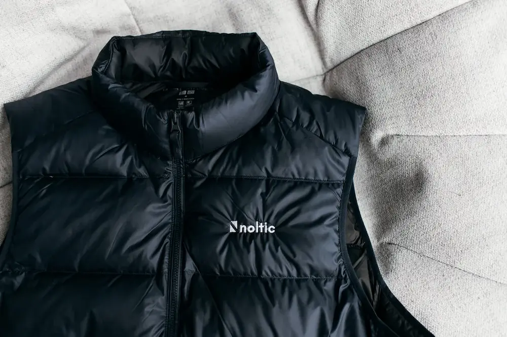 A black jacket with a white logo on it.