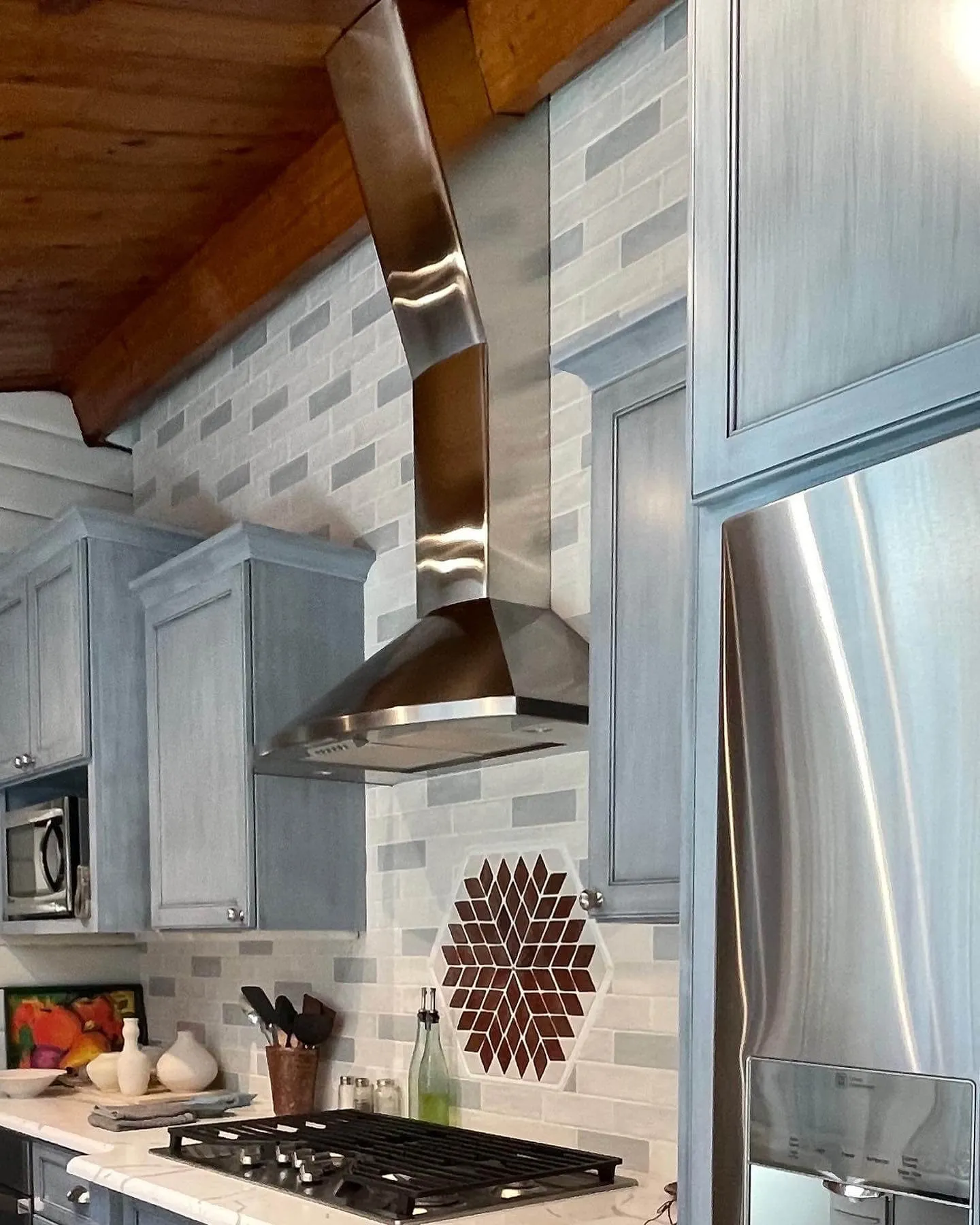 A kitchen range hood and kitchen cabinets