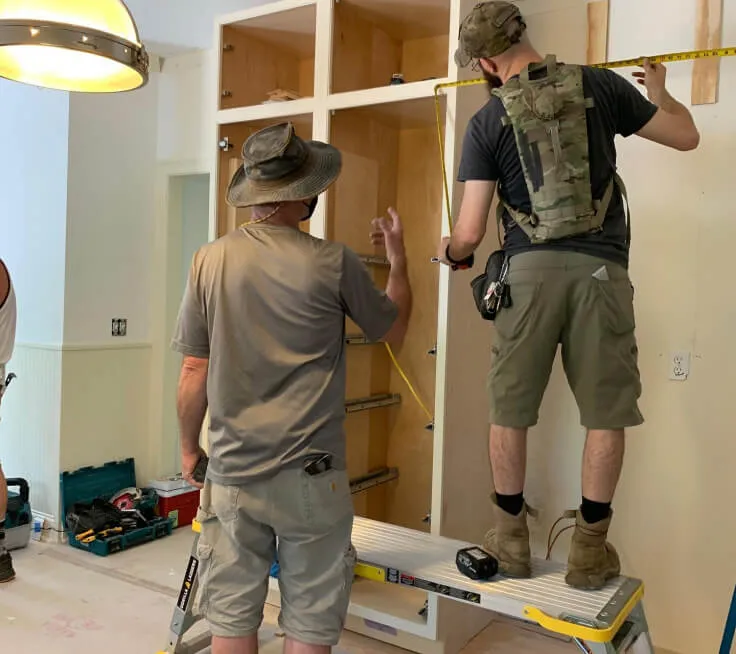 Our trade workers constructing cabinets in a client's home
