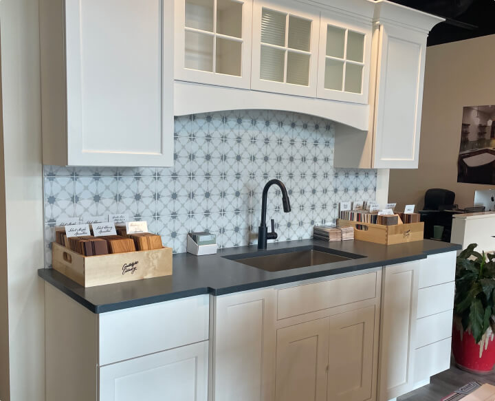 A custom white kitchen with white cabinets and a black countertop