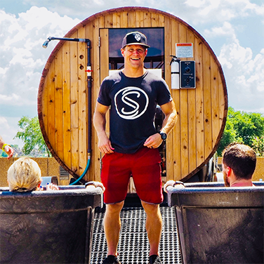 man standing in front of mobile sauna