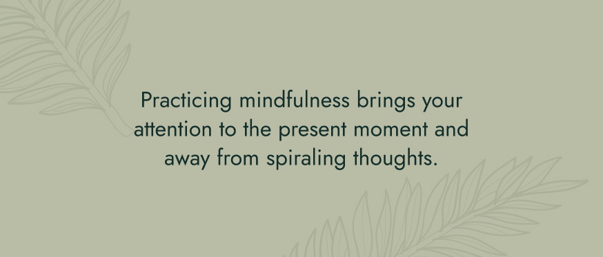 Image: Light green background with leaf print. Text: Practicing mindfulness brings your attention to the present moment and away from spiraling thoughts.