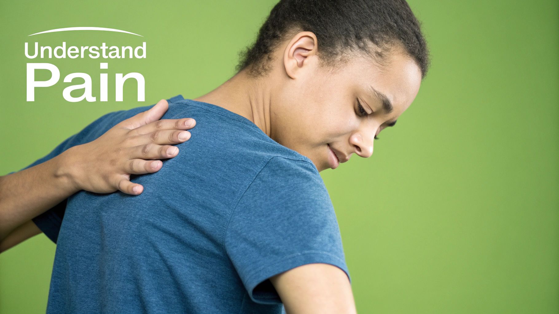 A person holding their lower left back in discomfort, indicating pain in that specific area.