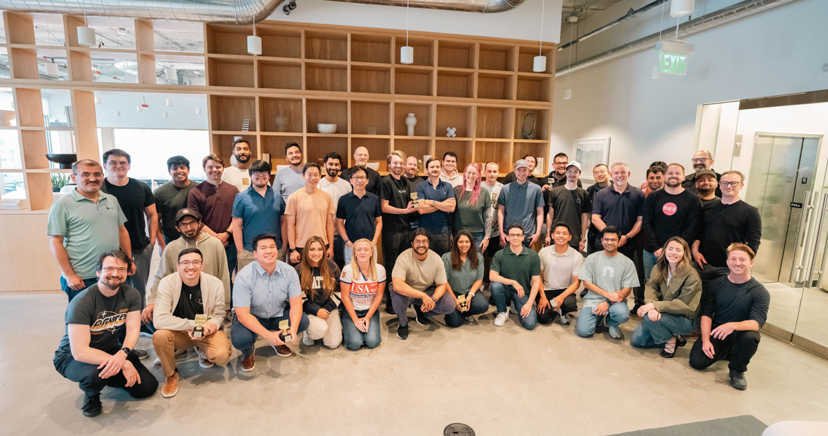 Team photo of all the hackathon participants, with the winners holding their trophies
