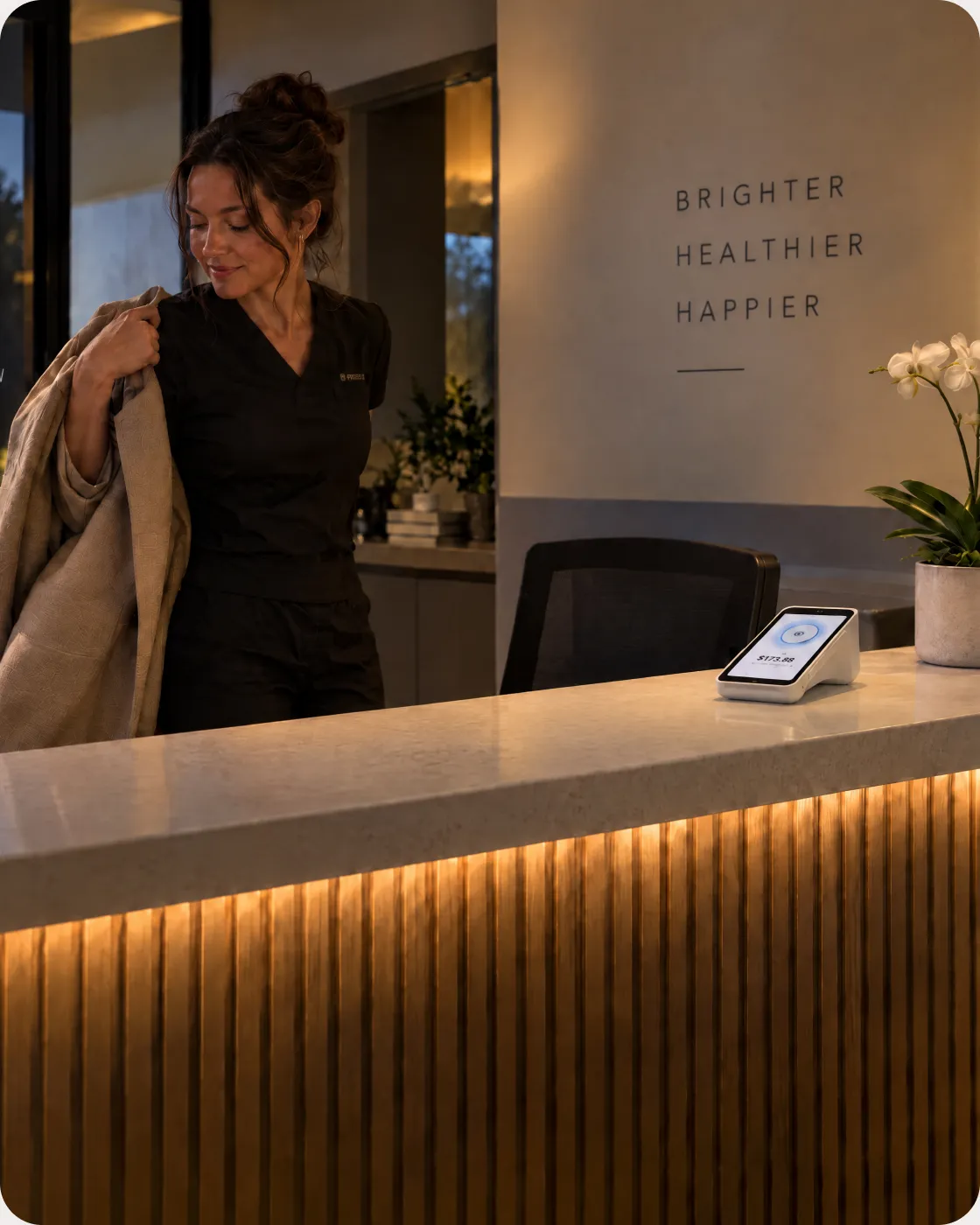 A front desk coordinator closing out the day at a dental practice