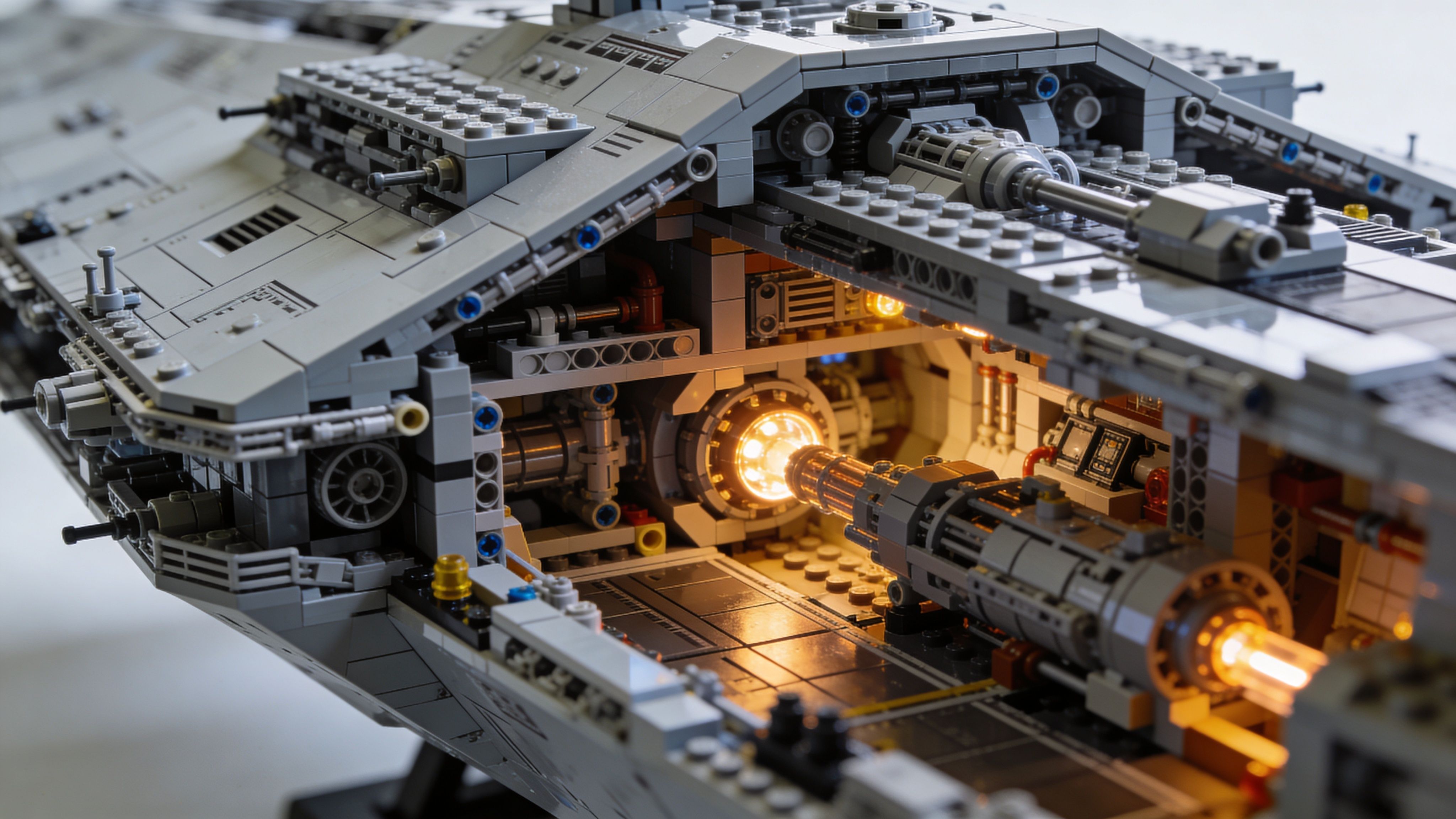 A highly detailed Lego Imperial Star Destroyer model featuring an illuminated interior hangar bay with glowing lights.