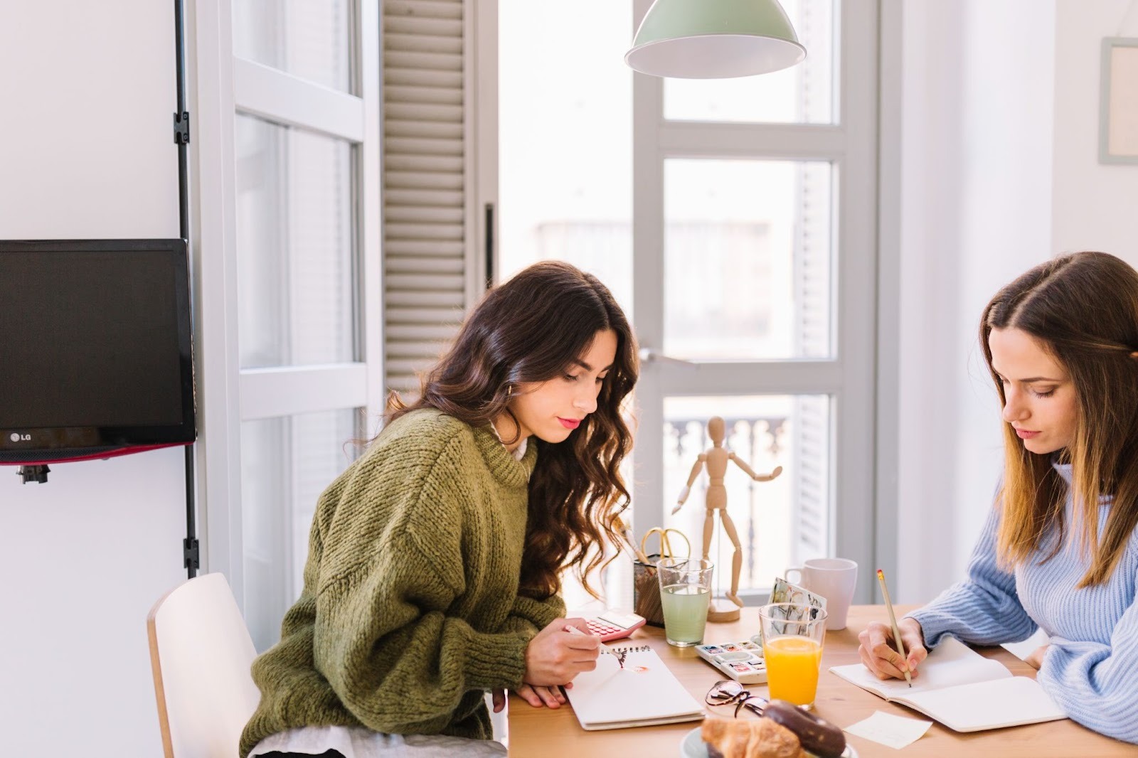 Two women engaging in a painting session at home