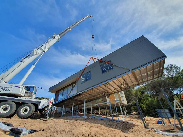 Crane lifting modular home