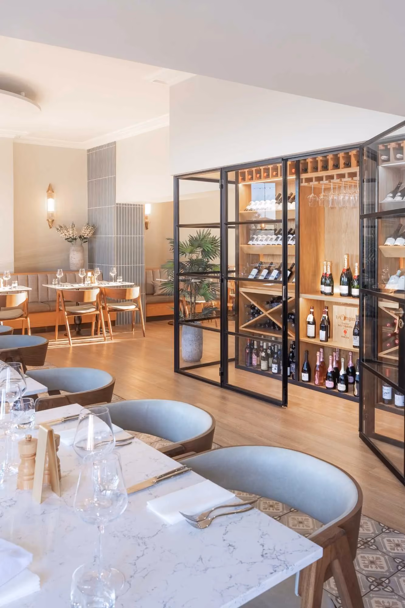 Dining room at The Goat restaurant at The Esplanade, Llandudno, with a glass-walled wine display