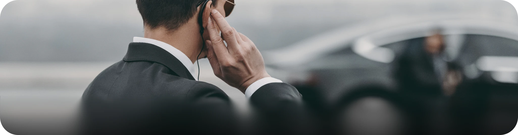 Savoya secure executive transportation: A professional security detail or close protection agent coordinating ground logistics for a high-profile client.