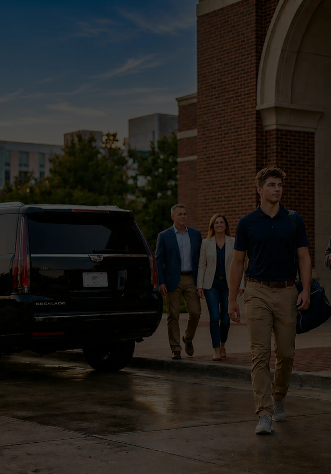 Professional group approaching a premium black SUV for executive transport services in an urban setting.