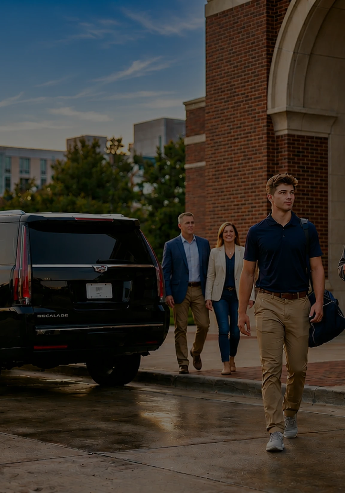 Professional group approaching a premium black SUV for executive transport services in an urban setting.