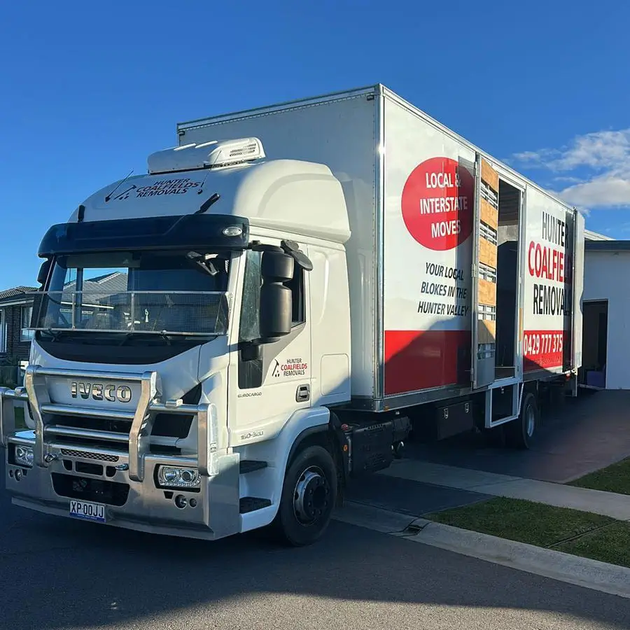 White Iveco Removalists truck in Maitland parked on a suburban street.