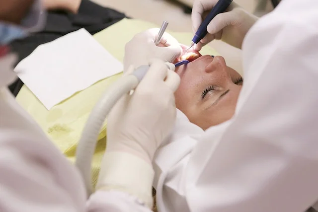 Dentist reviewing a patient’s smile as part of full mouth rehabilitation planning.