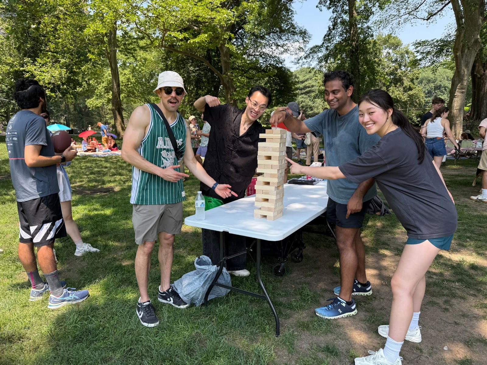 Viam team members posing with a Jenga tower
