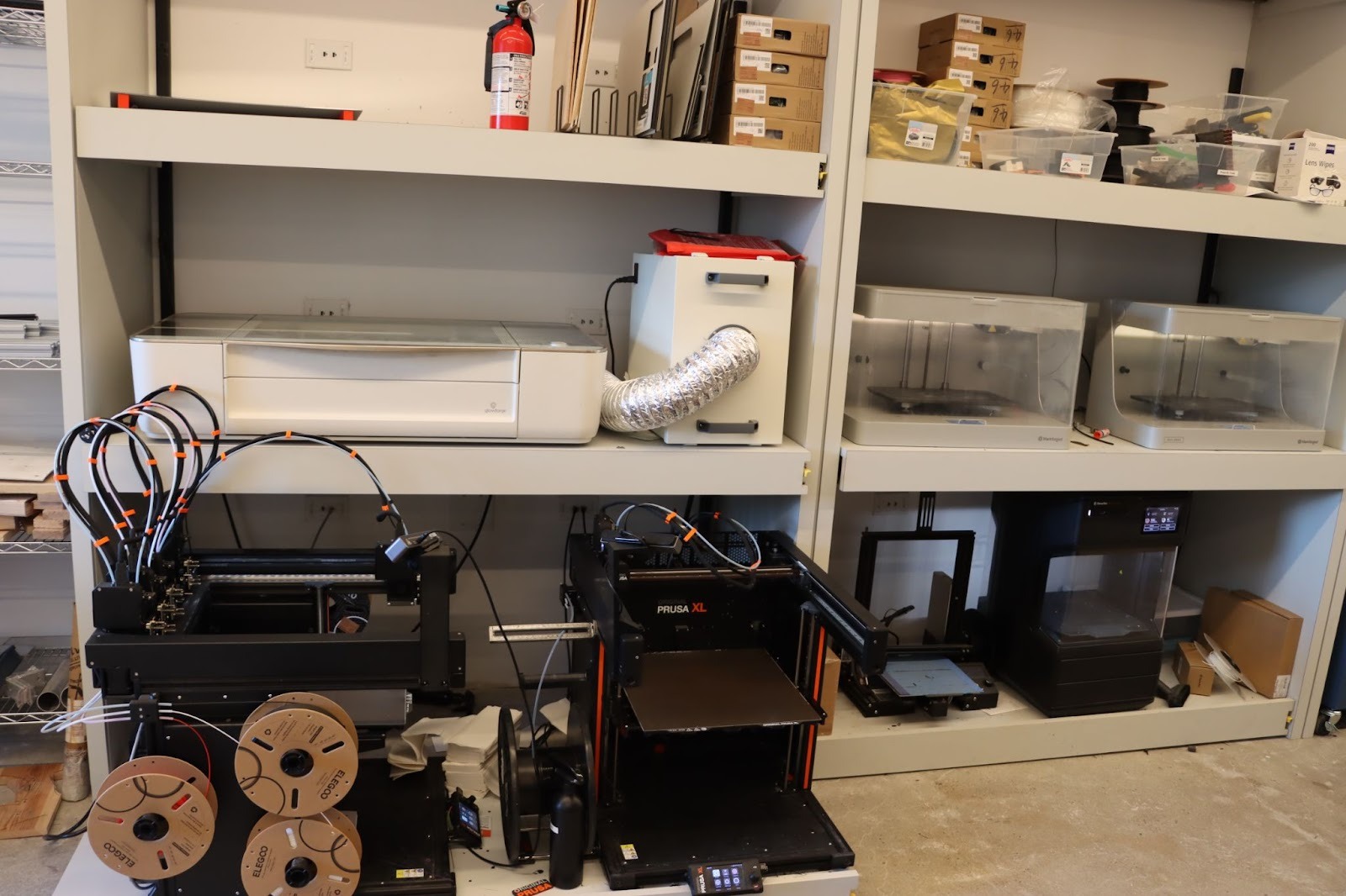 Shelves of 3D printers in the Viam lab.