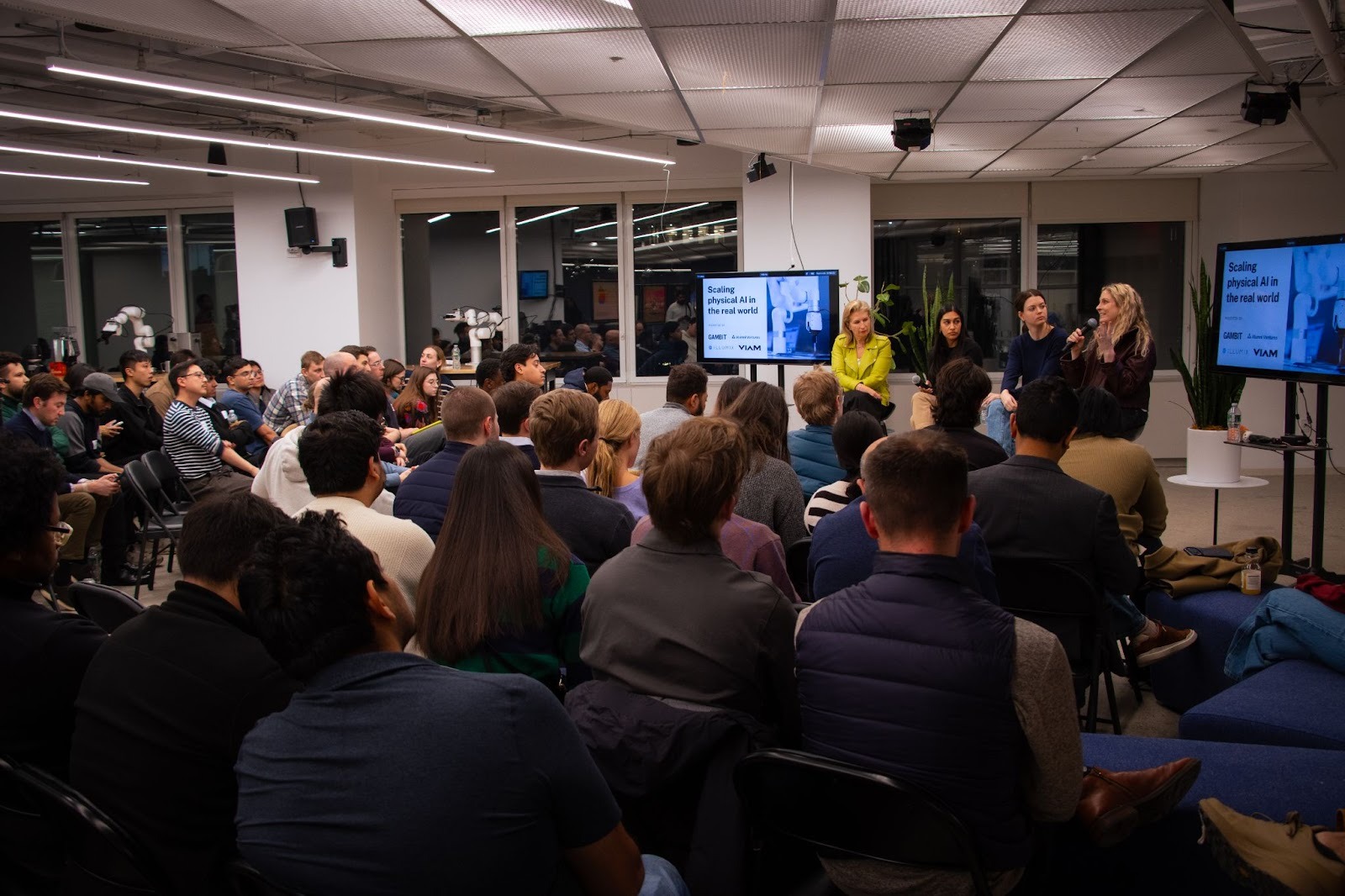 Image of panel sitting in front of audience
