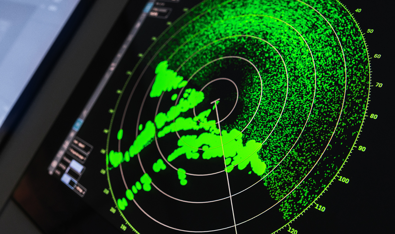 A photo of a radar screen on a ship control panel
