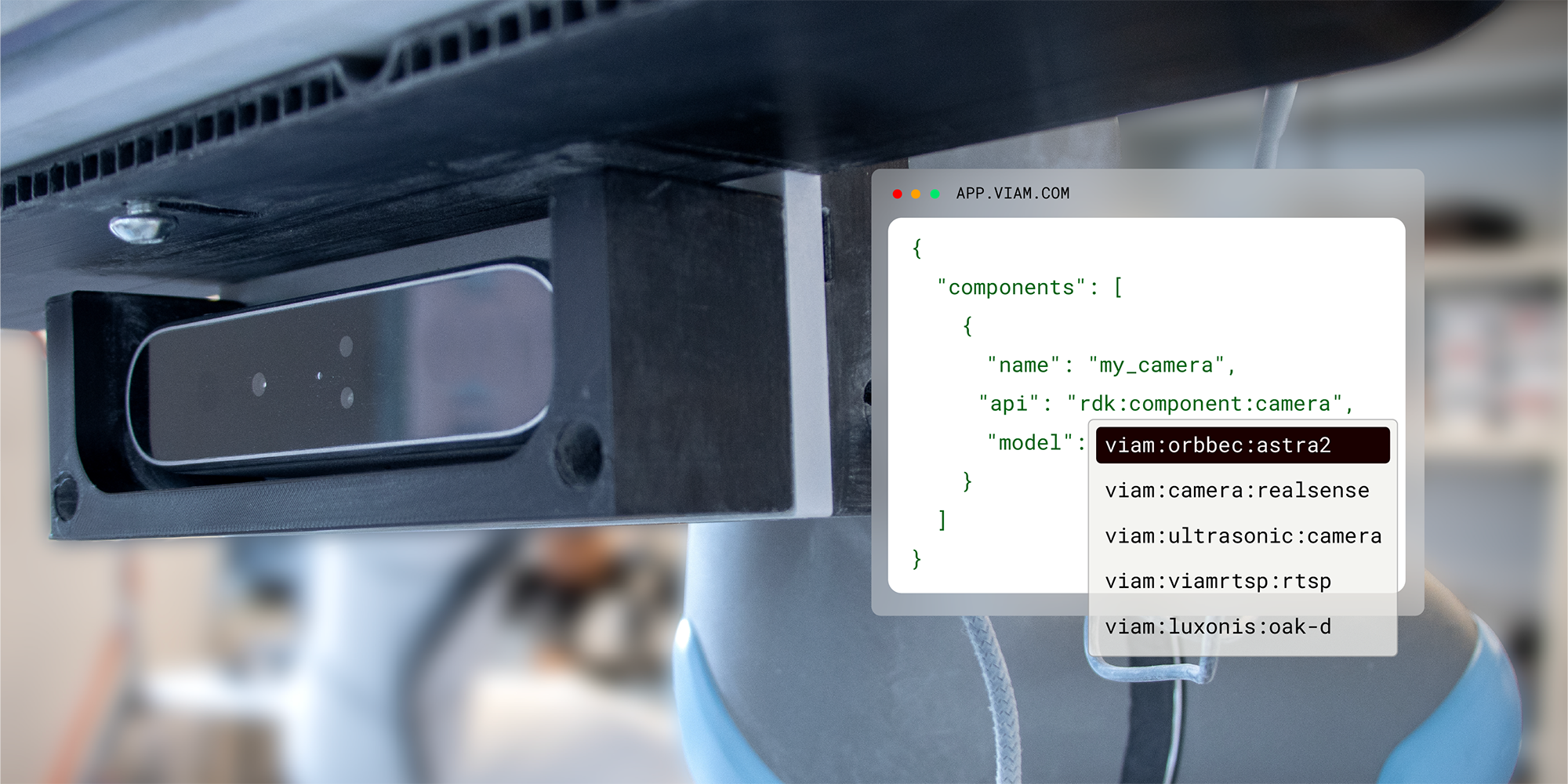 A photo of an Orbbec camera mounted onto a robotic arm. A block of code is overlaid showing how simple it is to swap your hardware in the Viam app.
