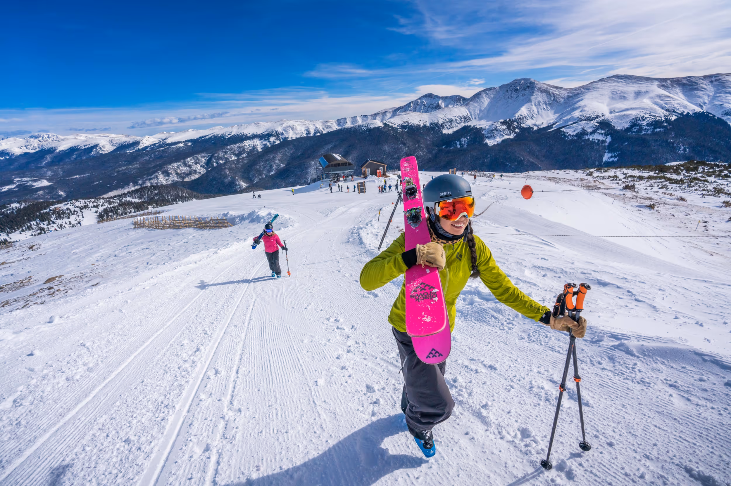 A skier boot packing up a snow covered slope 