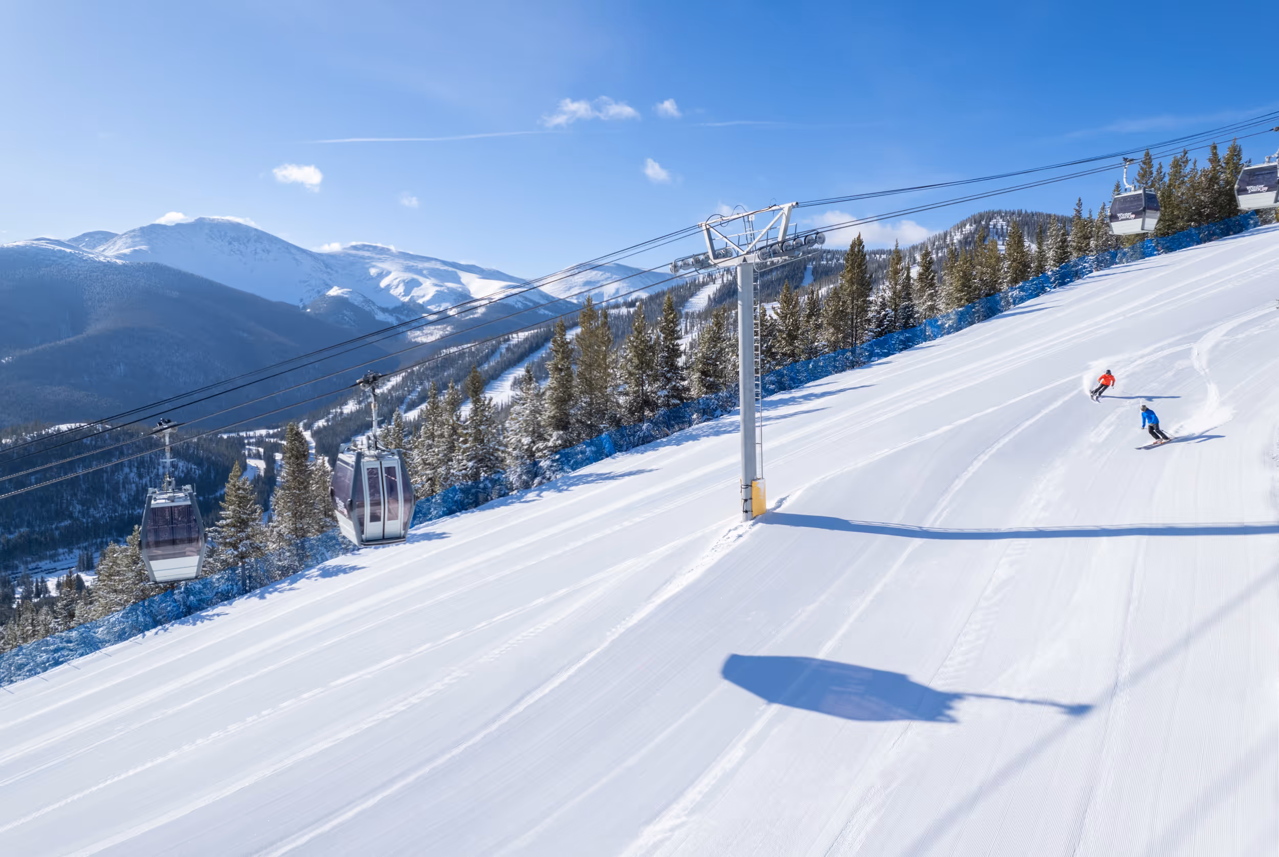 2 skiers ripping some groomers at Winter Park