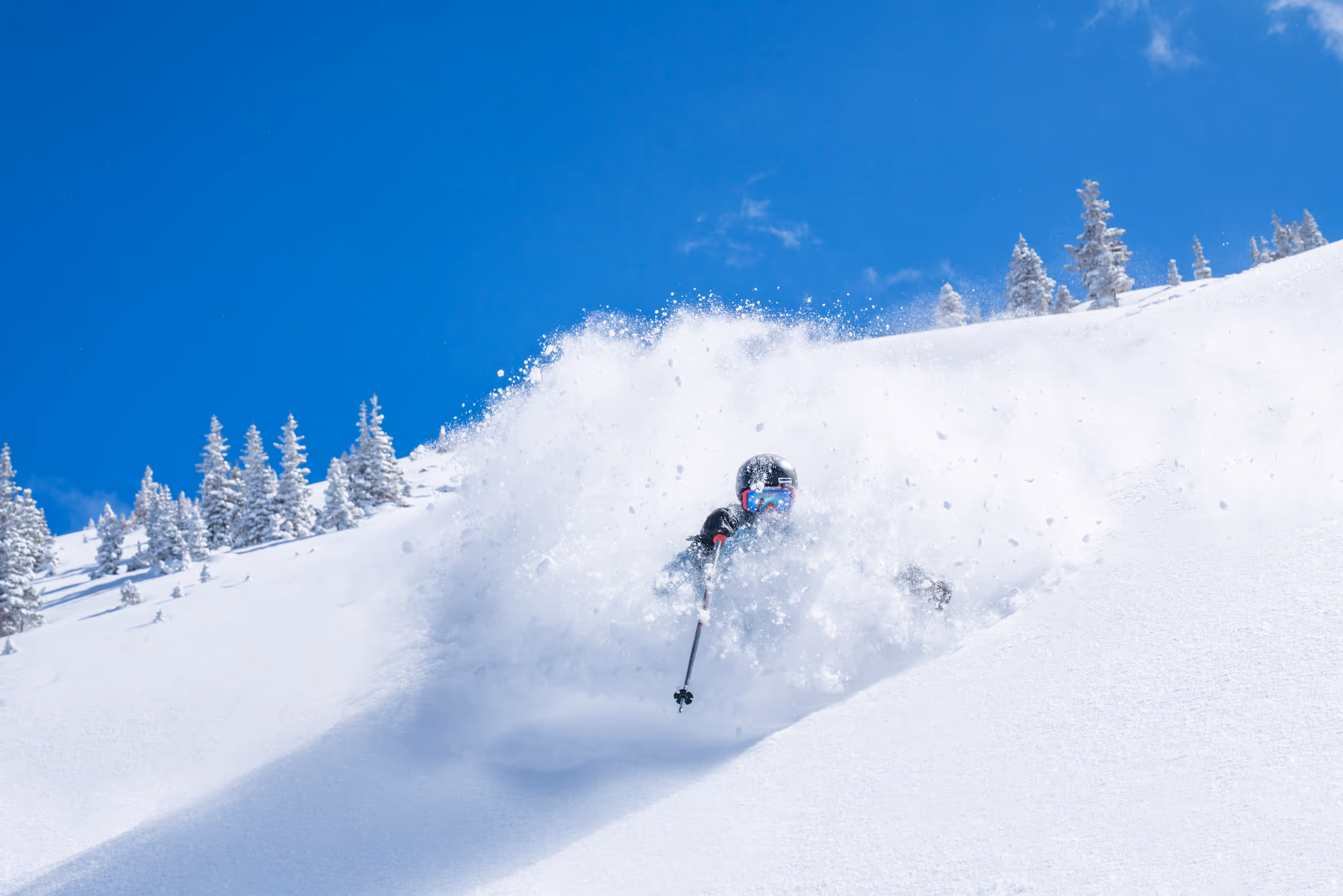 A skier getting some sick face shots and POW turns at Winter Park 