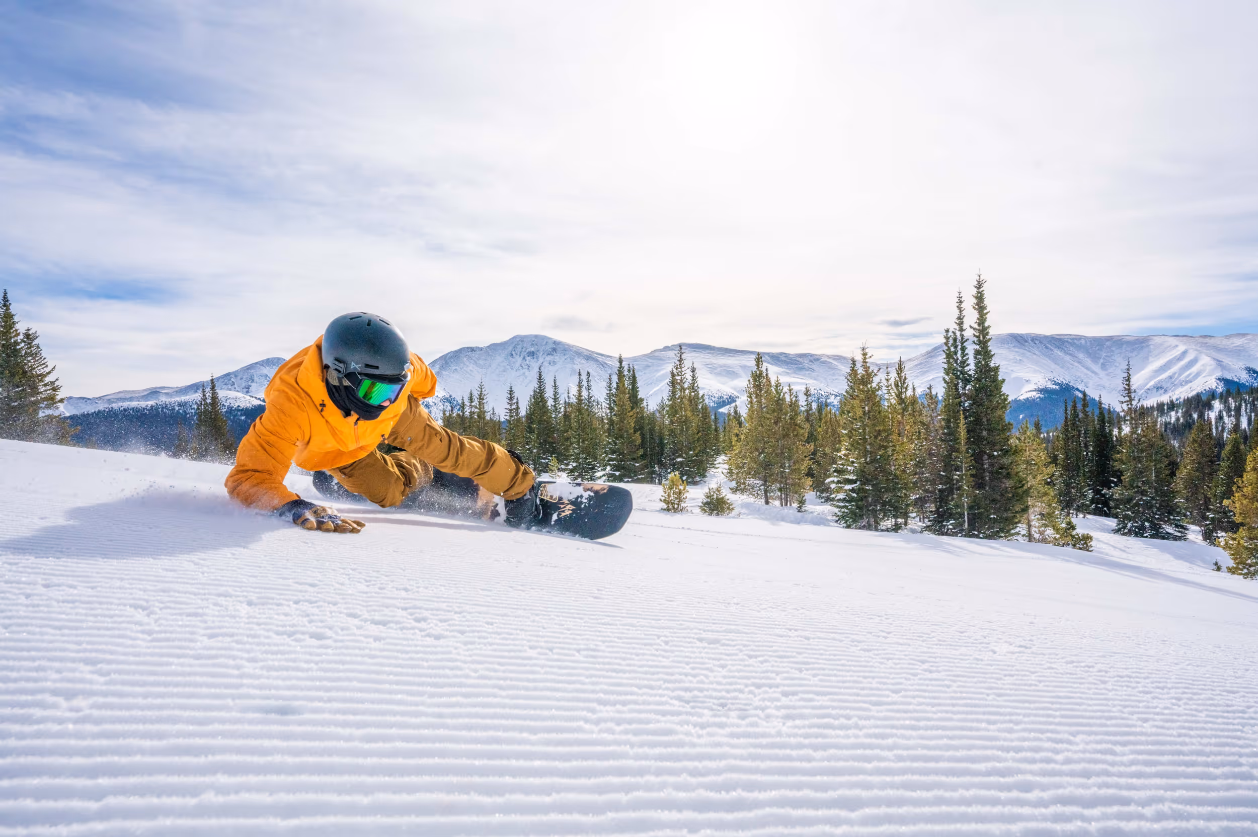 A snowboarder ripping groomers at Winter Park 