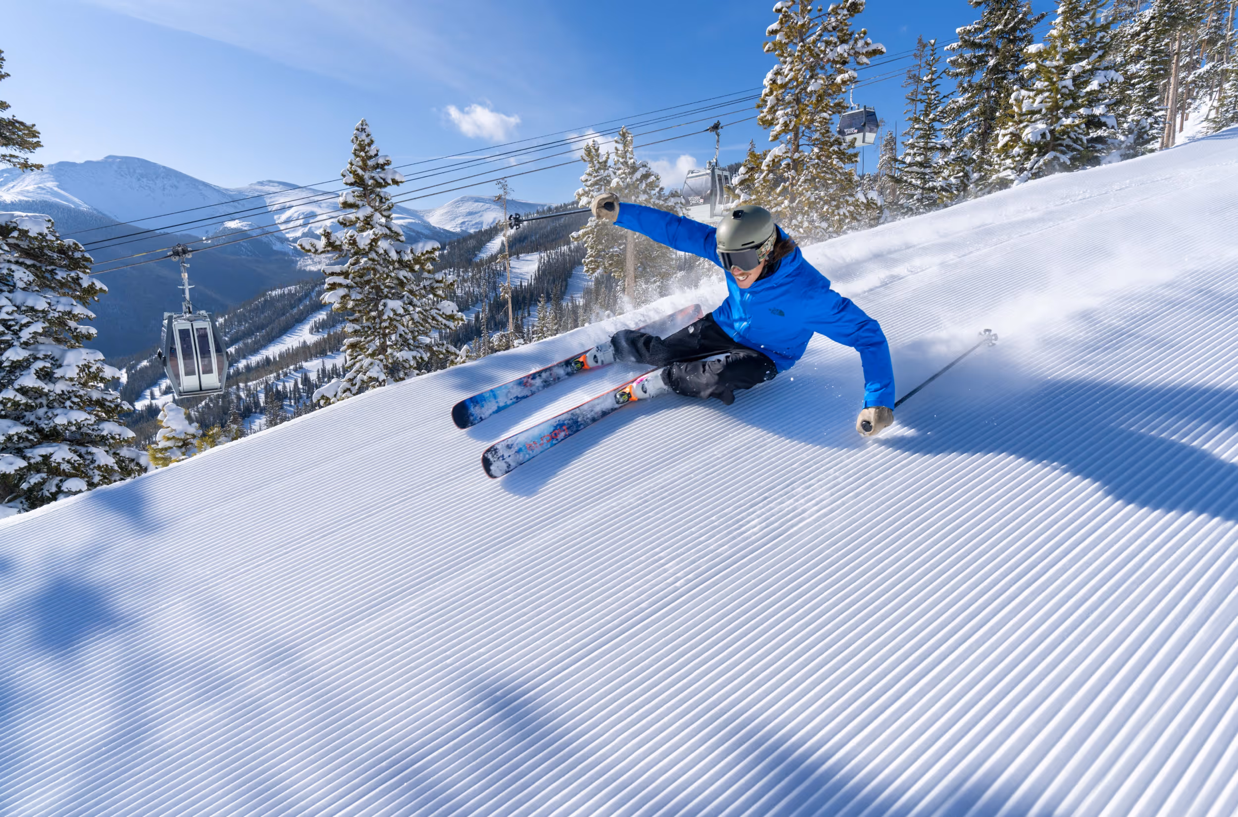 A skier crushing a groomer at Winter Park 