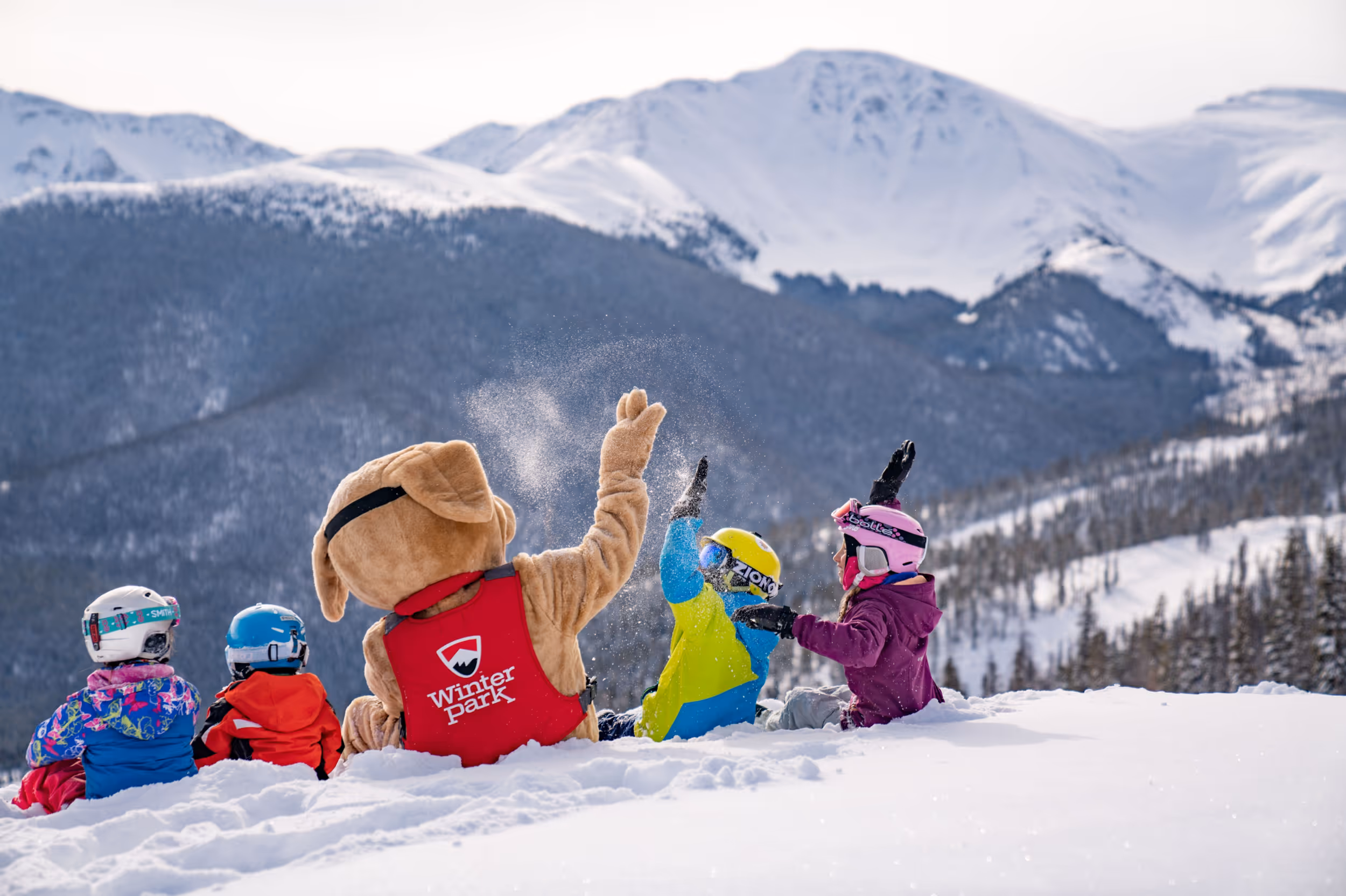 Some young skiers hanging out with the Winter Park mascot on the slopes 