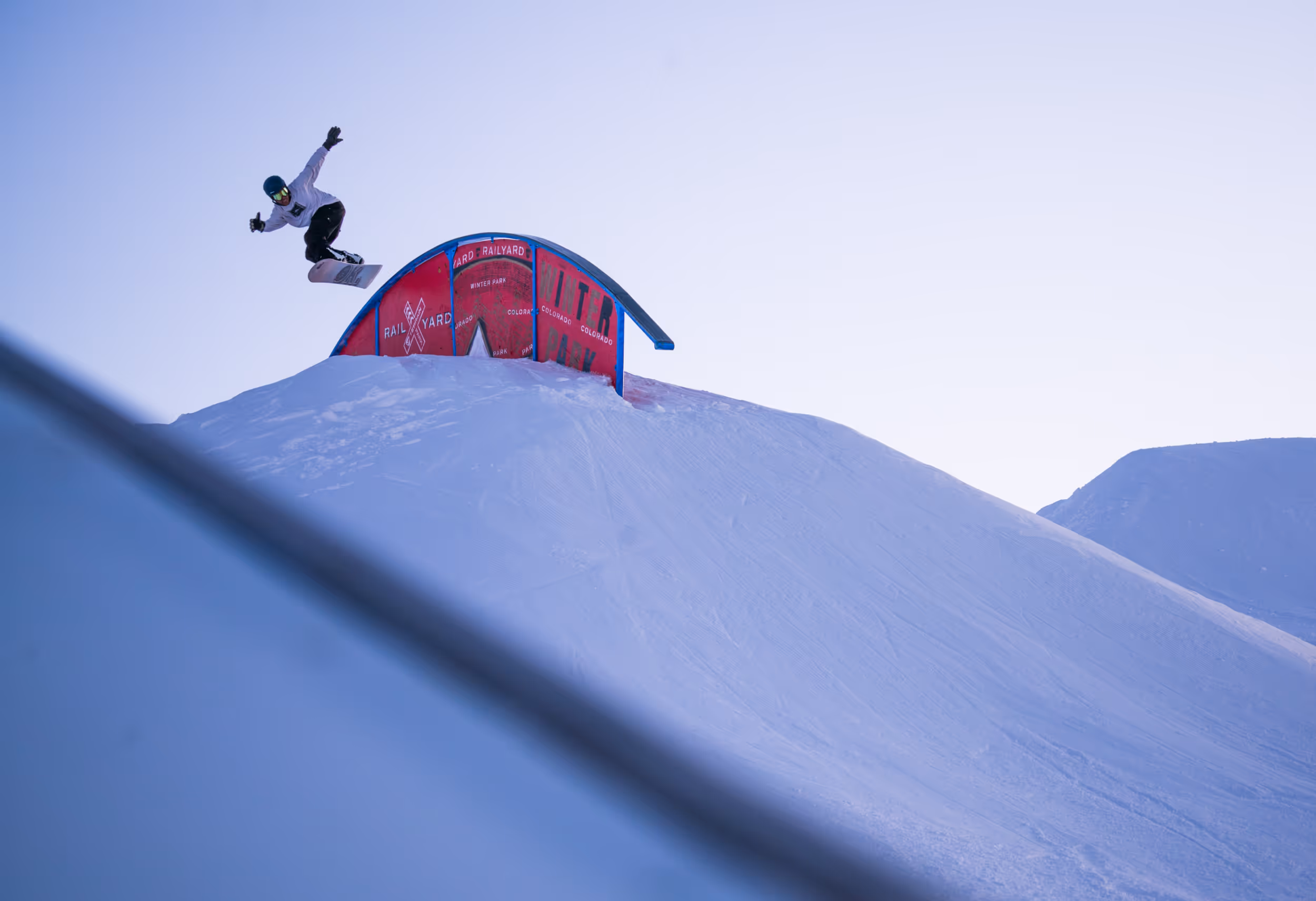 A snowboarder enjoying the terrain park 