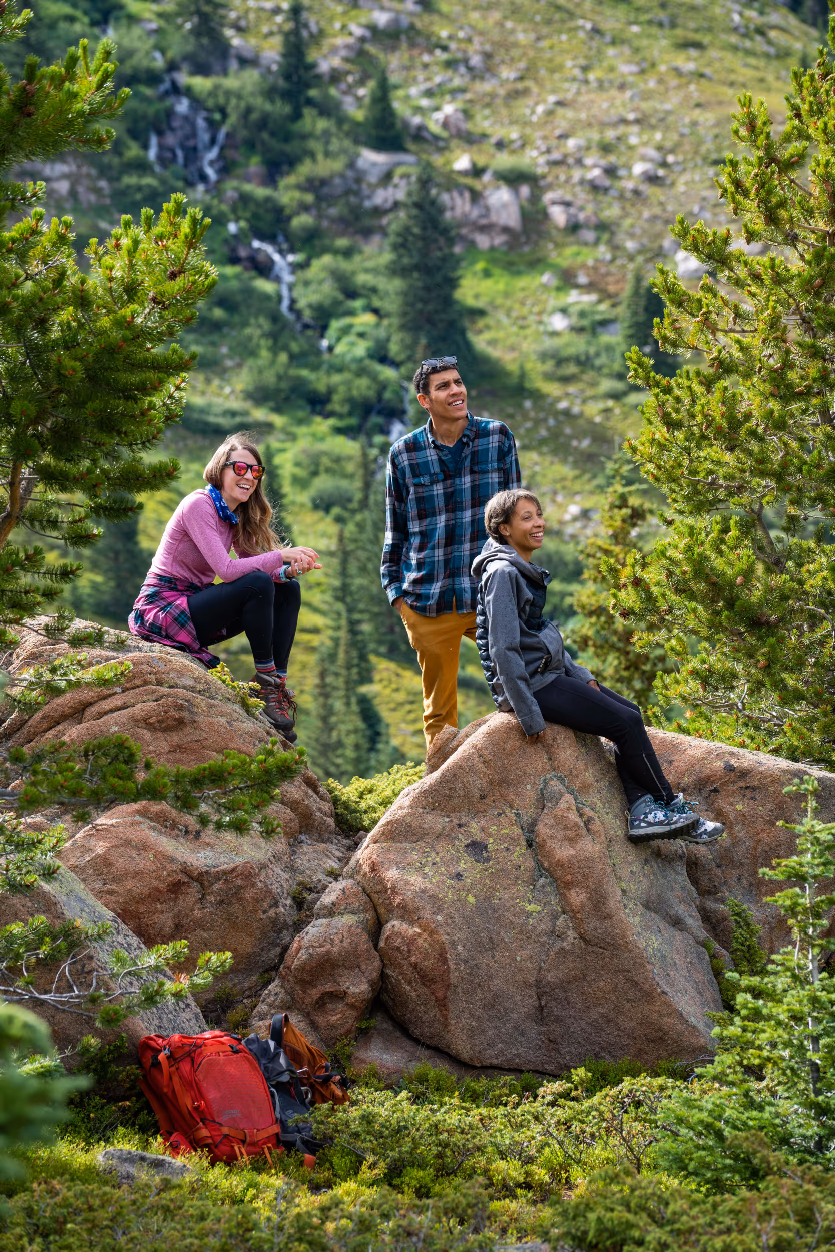 Some hikers taking a break on some rocks 
