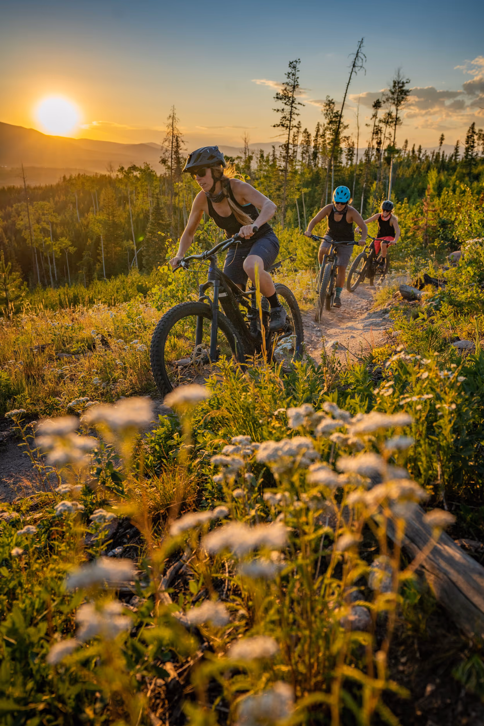 Some ladies crushing it on some electric bikes during golden hour