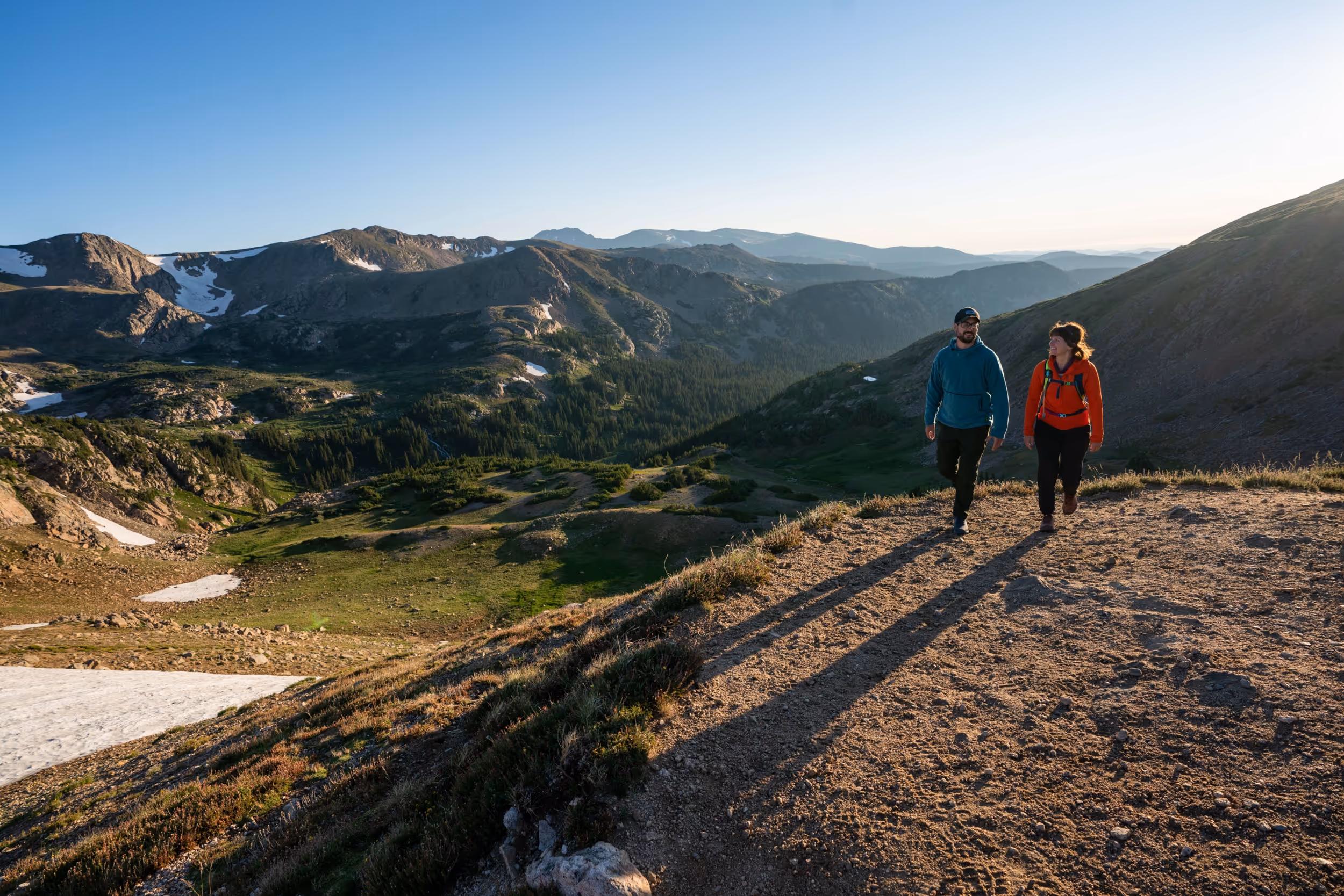 Some hikers getting to the top of their hike while the sun is beginning to set 