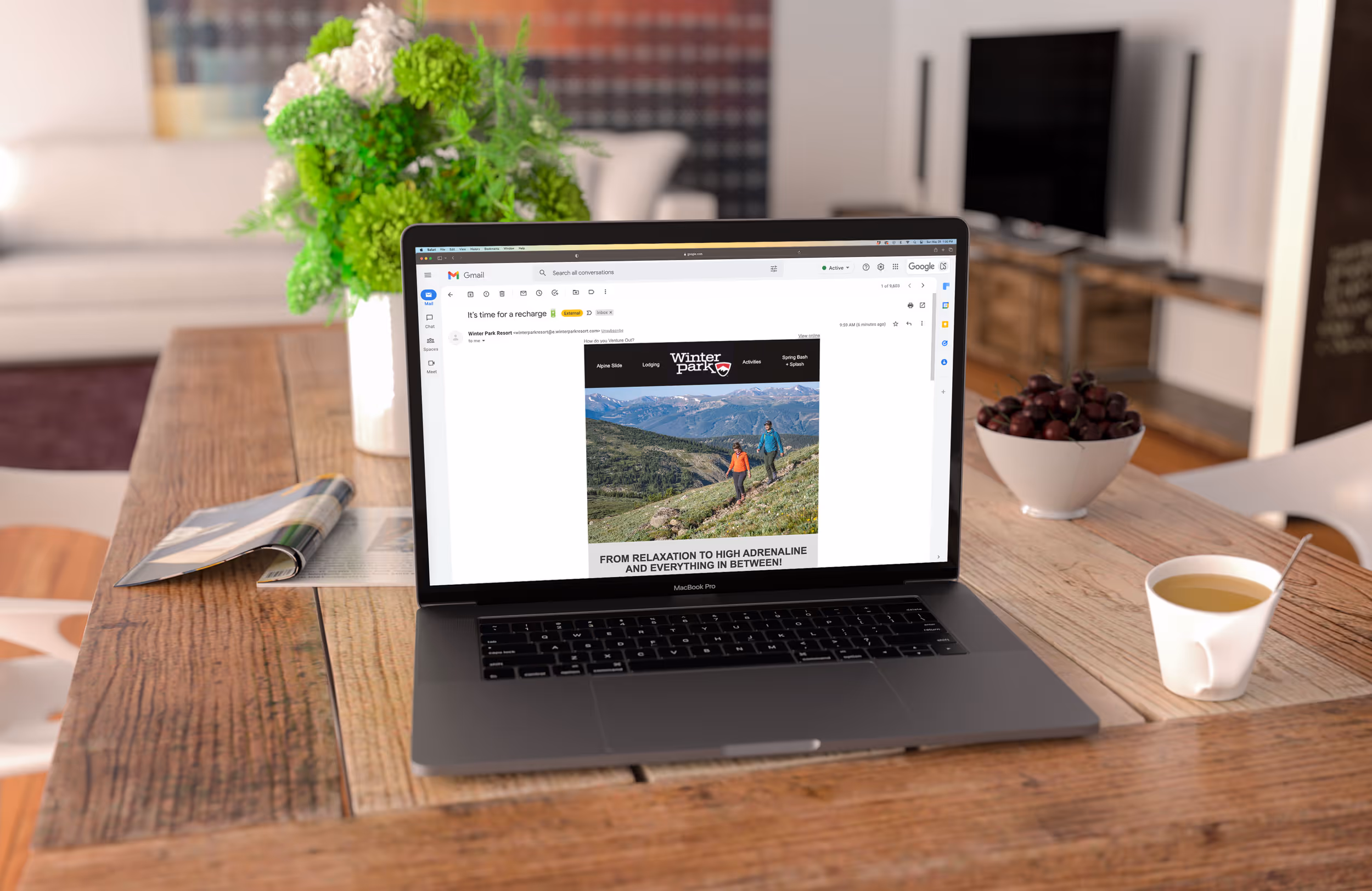 An image of a laptop opened to Winter Parks website showing some hikers coming up a pass 