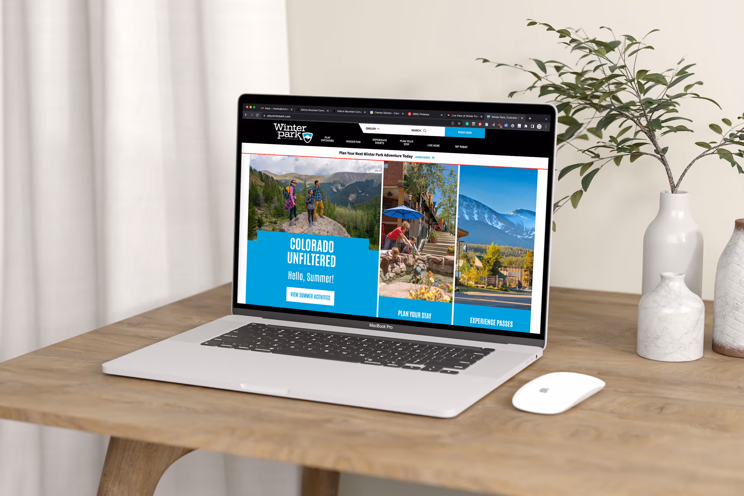 An image of a laptop opened to Winter Parks website showing some hikers coming up a pass 