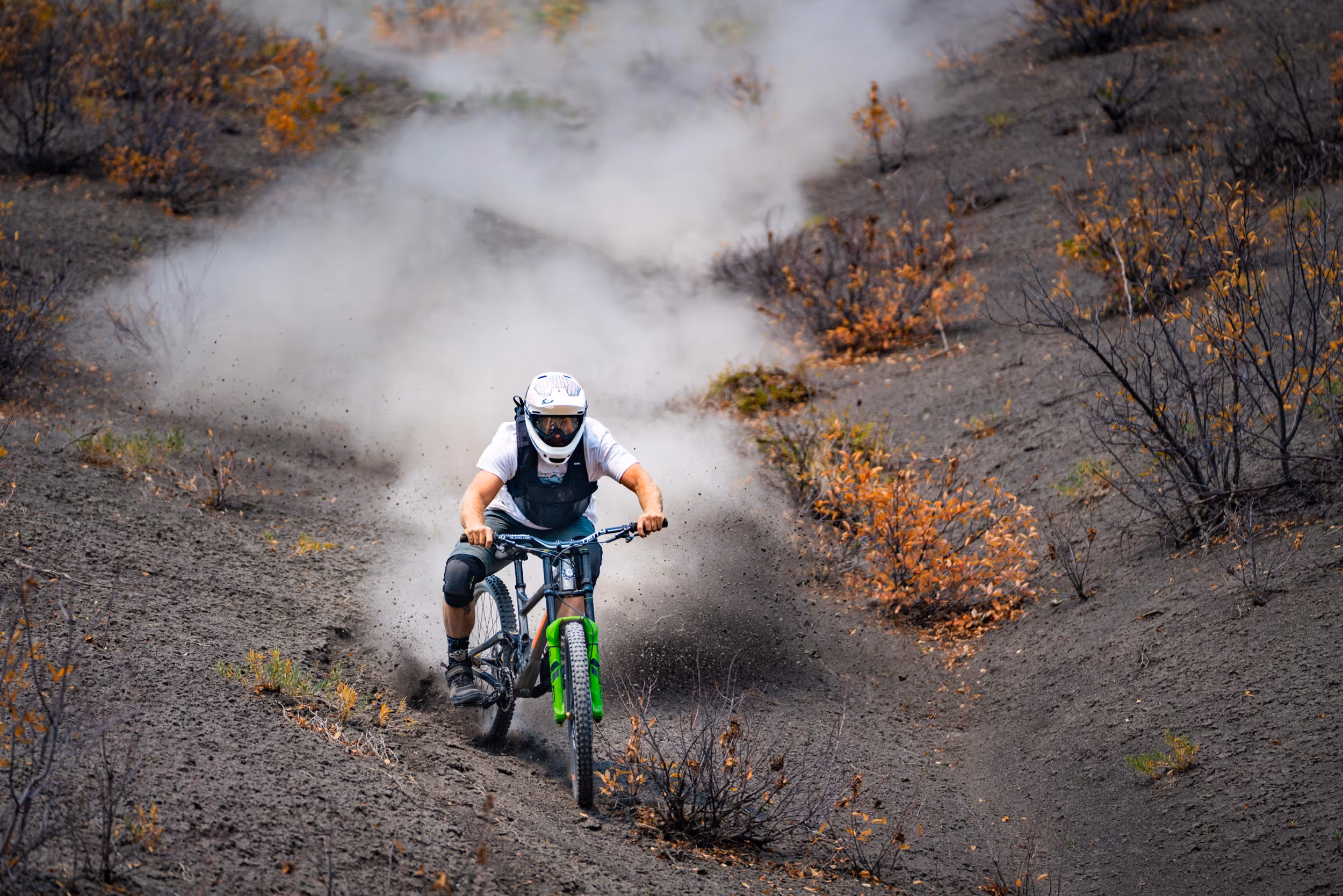 A mountain biker heading down a sick, steep,  chossy trail 