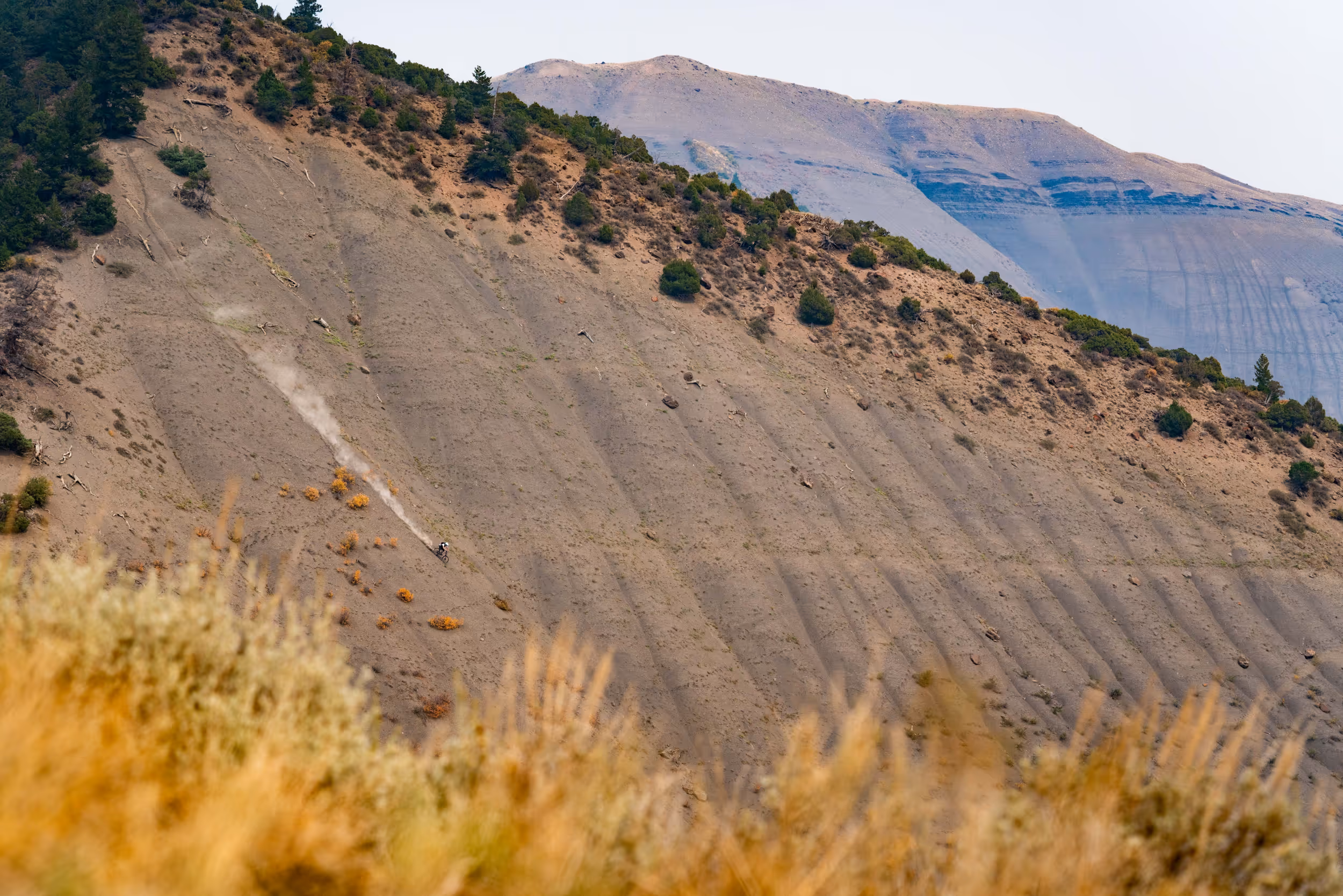 A mountain biker heading down a sick, steep,  chossy trail 