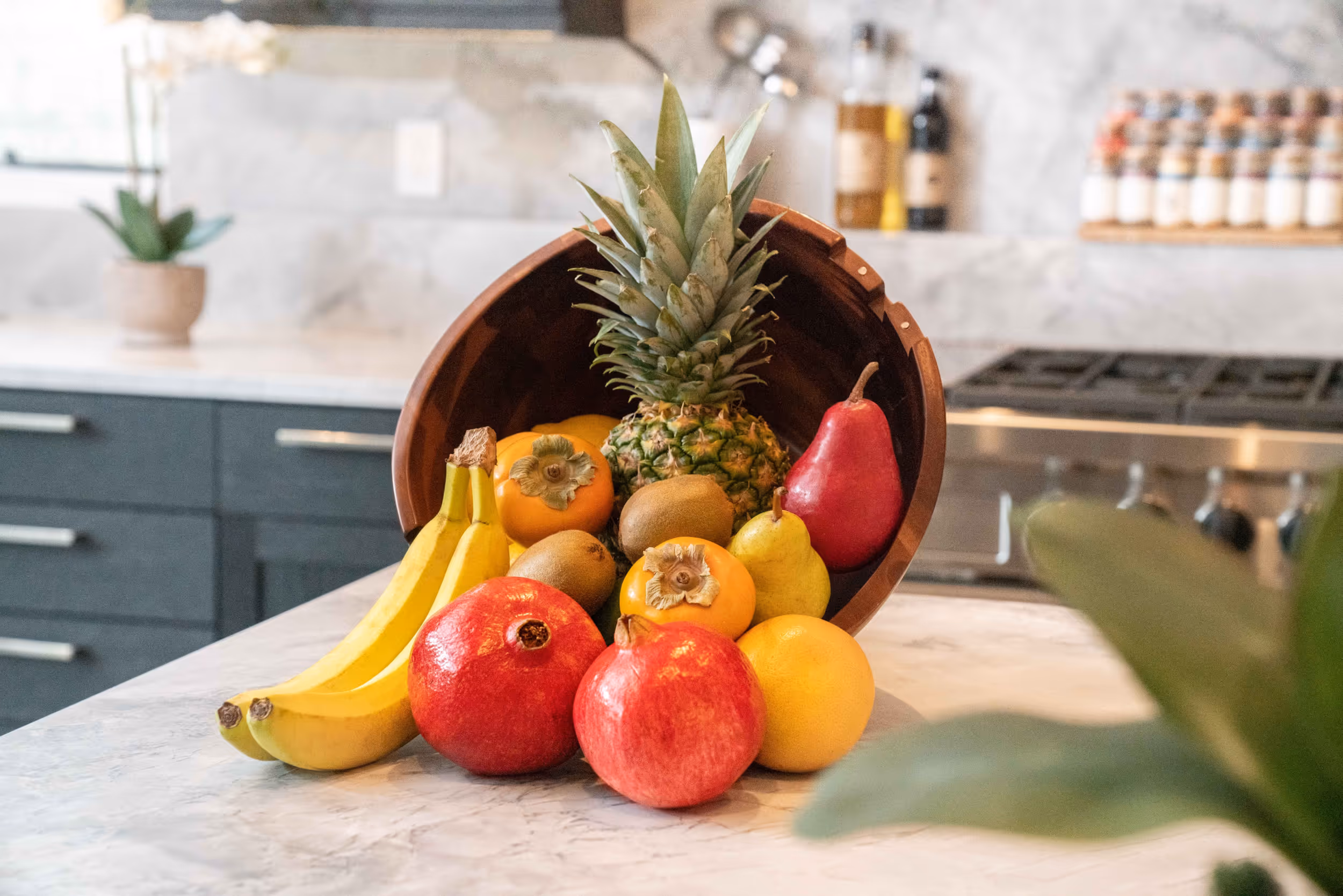 A colorful basket of fruit on a marble countertop 