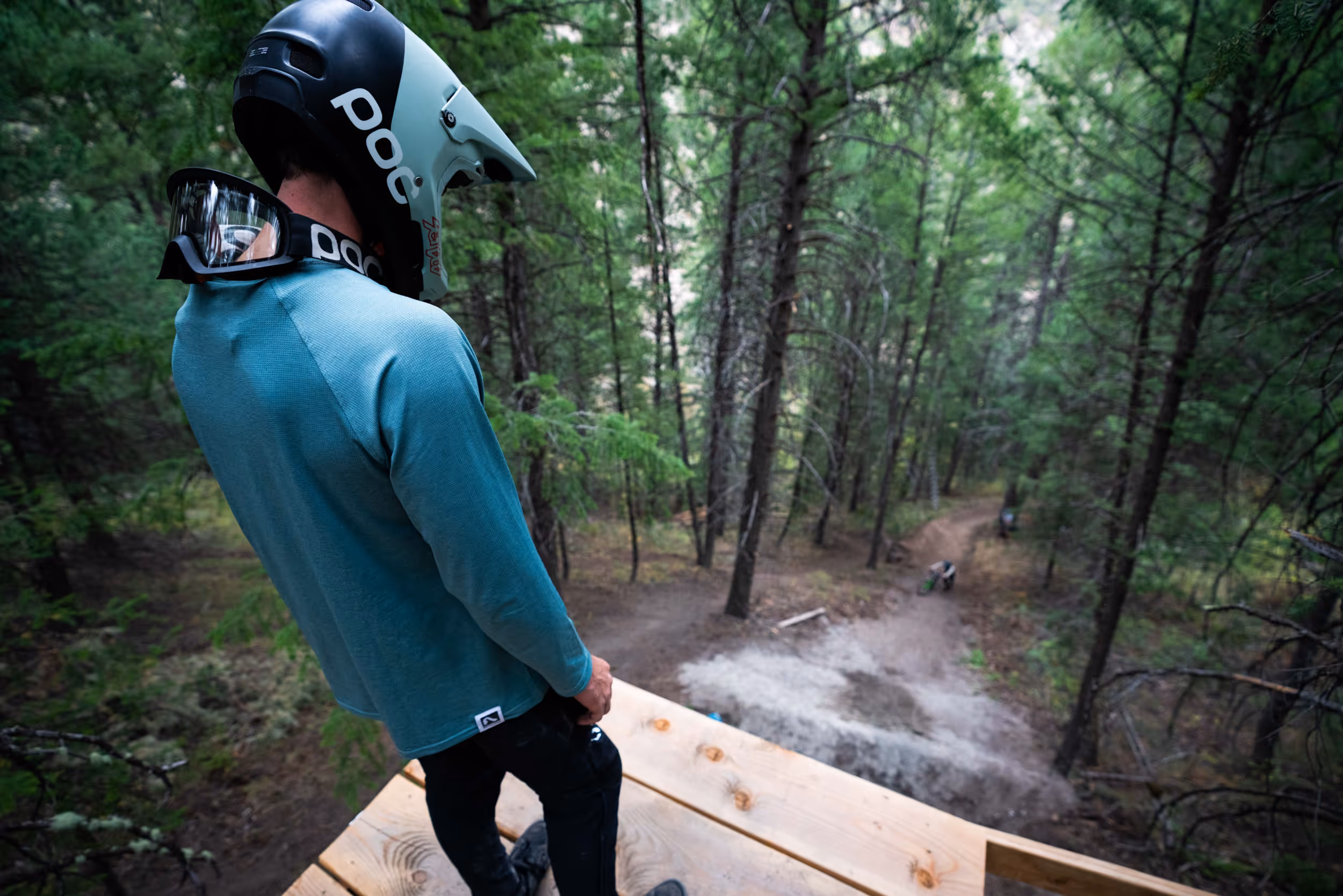A mountain biker scouting a large jump 