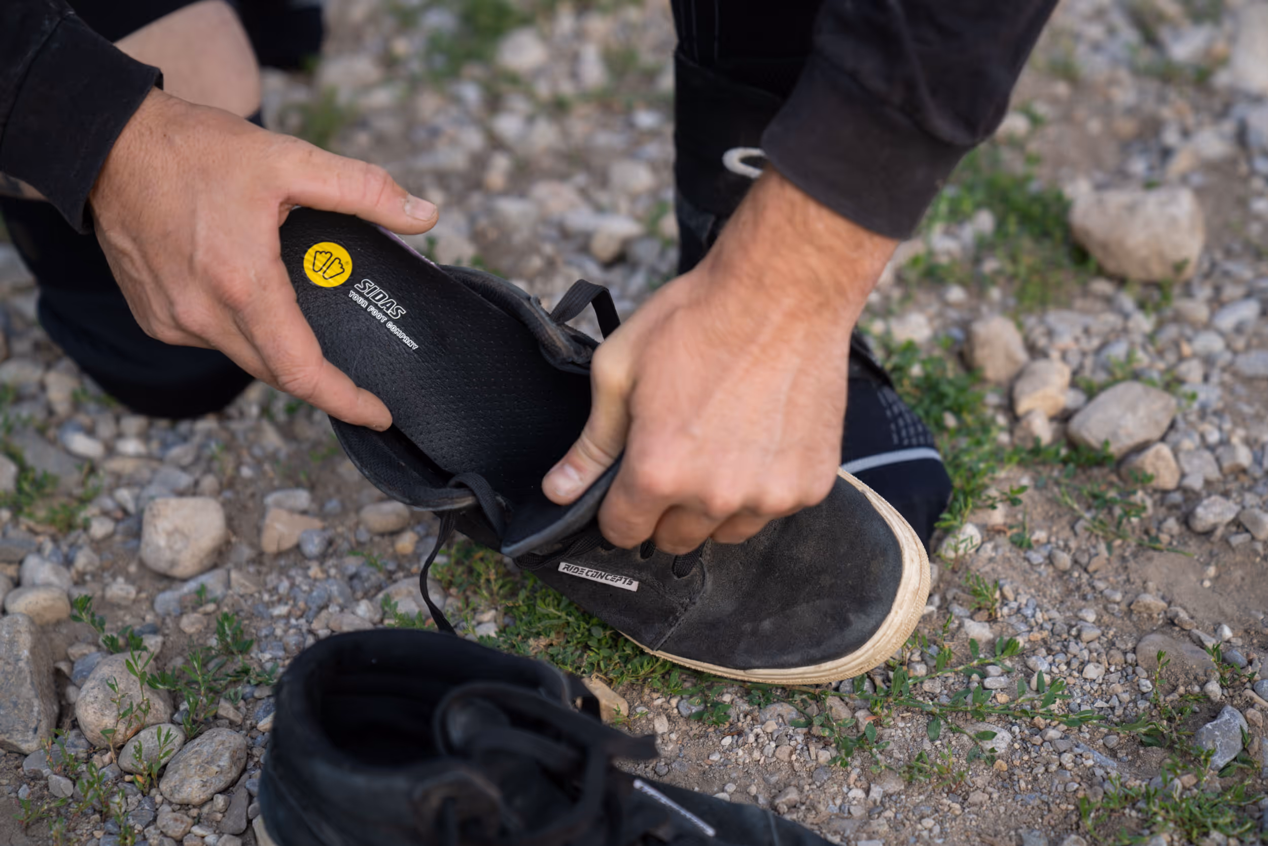A man putting in some insoles for mountain biking 