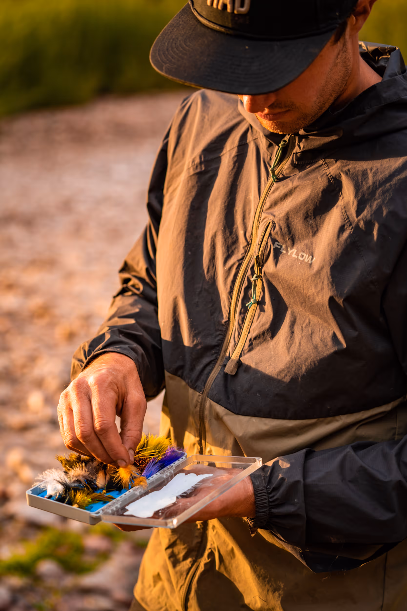 A fly fisherman picking out the perfect lure 