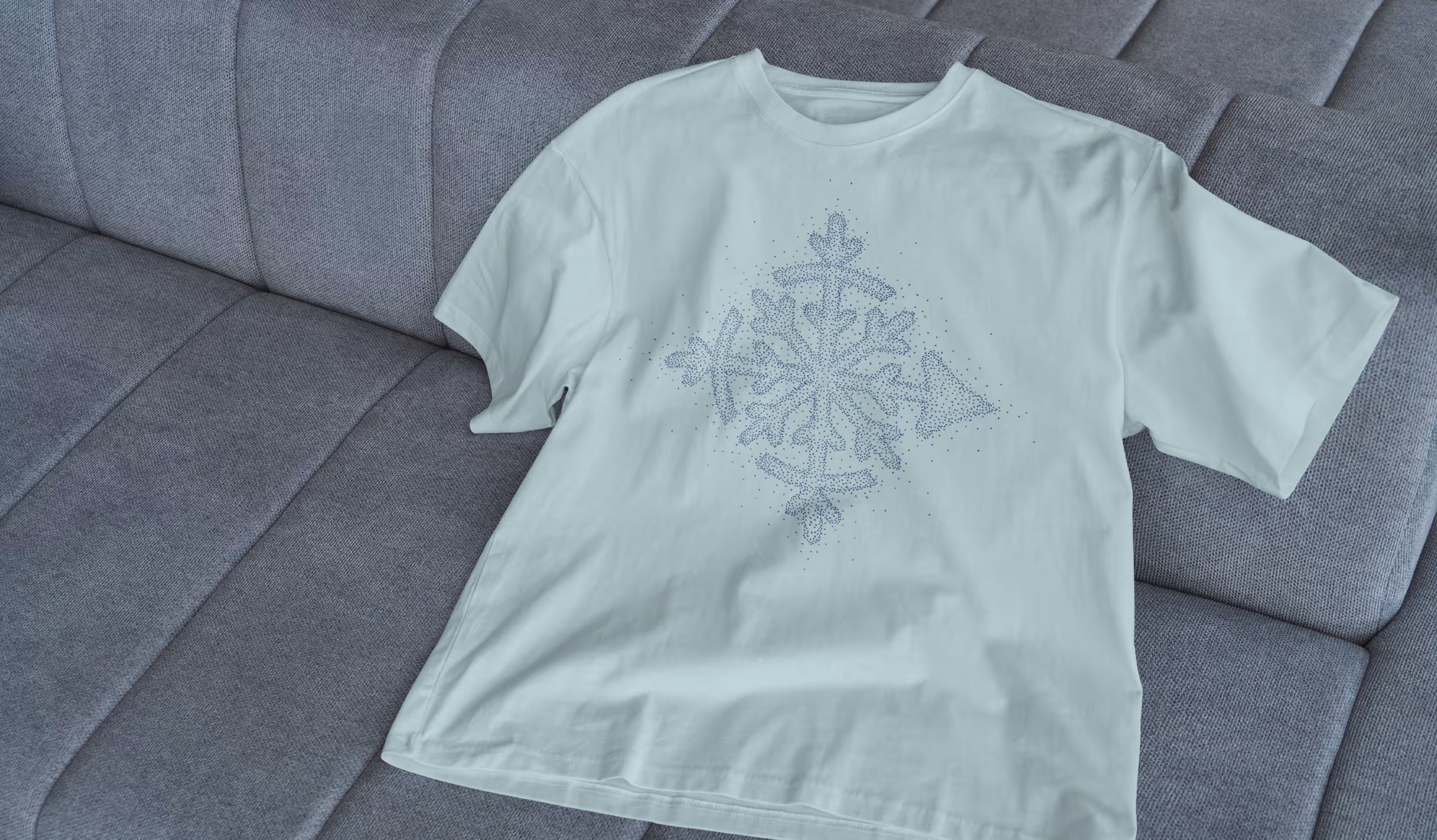 A lighter colored t-shirt with a darker colored snow-flake pattern