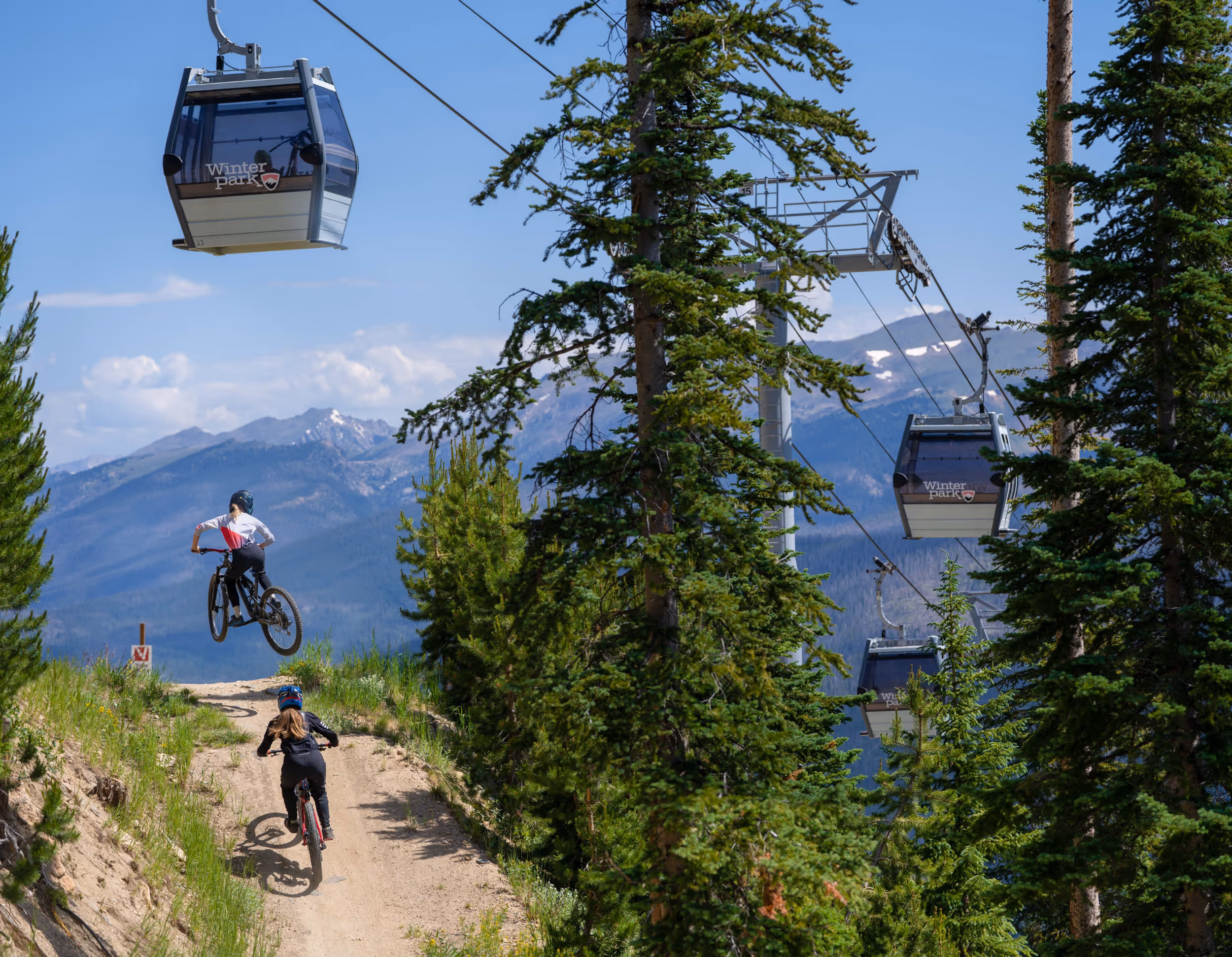 A mountain biker getting some sick air just below the gondola 