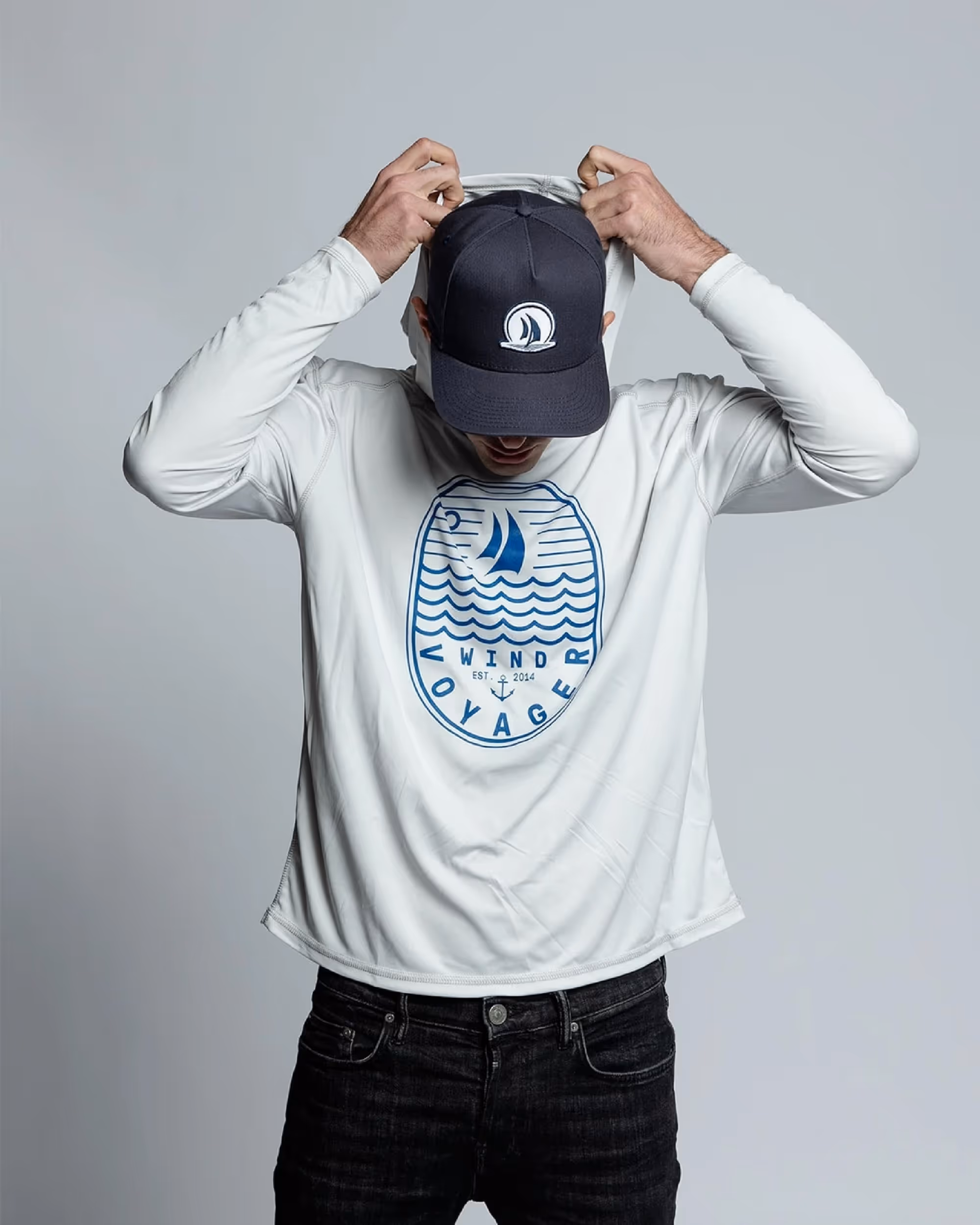 Man wearing light blue Wind Voyager hooded sun shirt 
