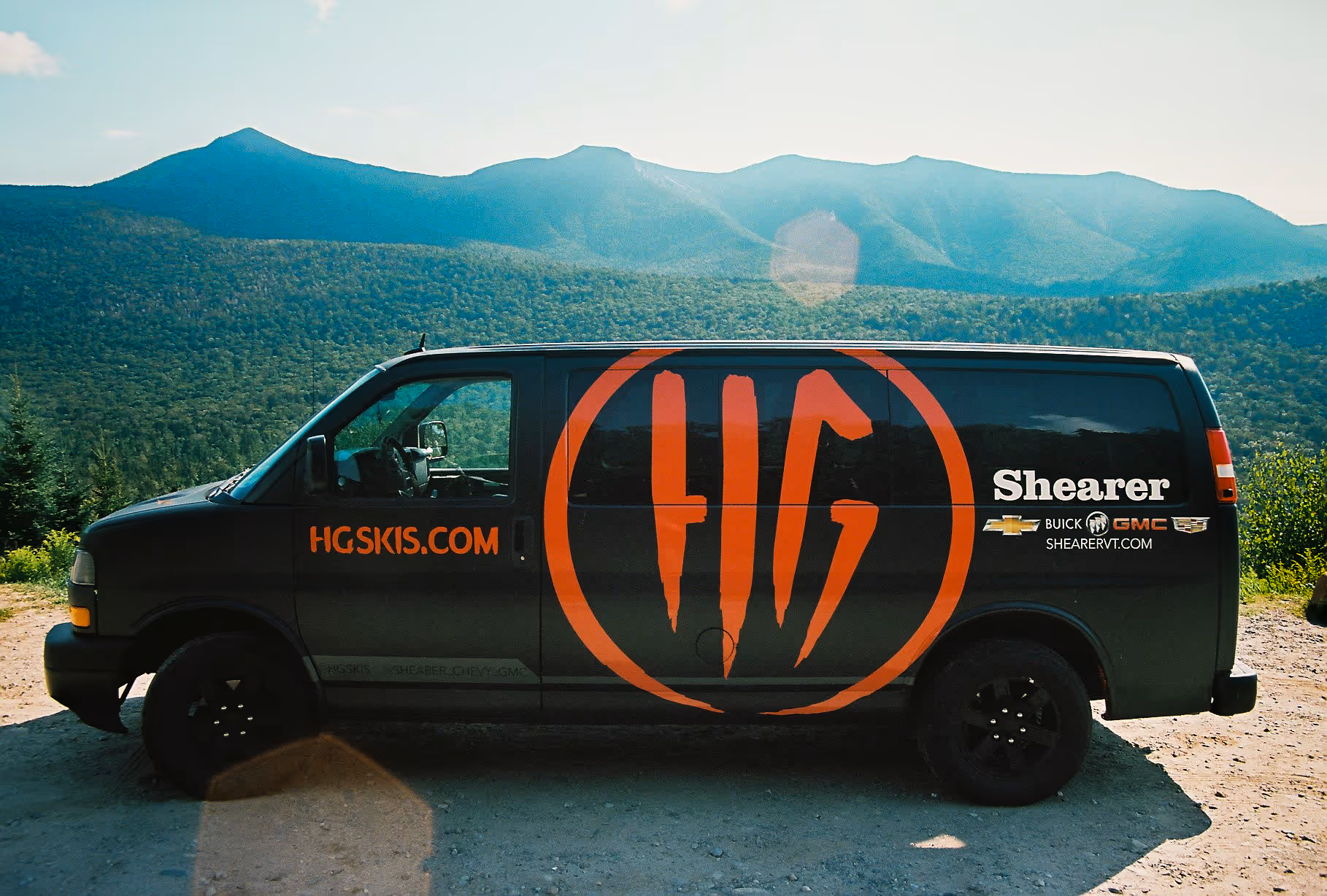 A black HG Ski van with an orange HG ski logo