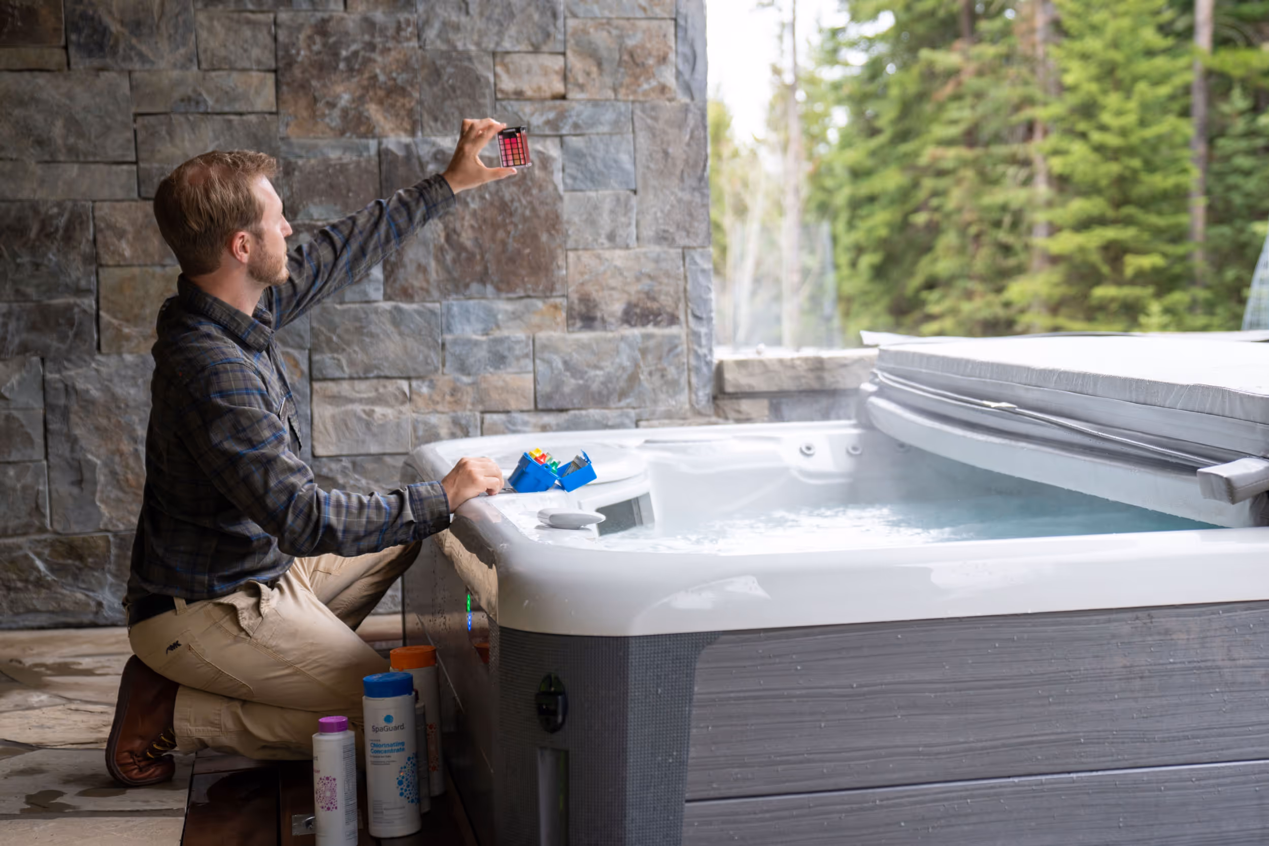 A Yellowstone Club employee checking the water quality of a hot tub