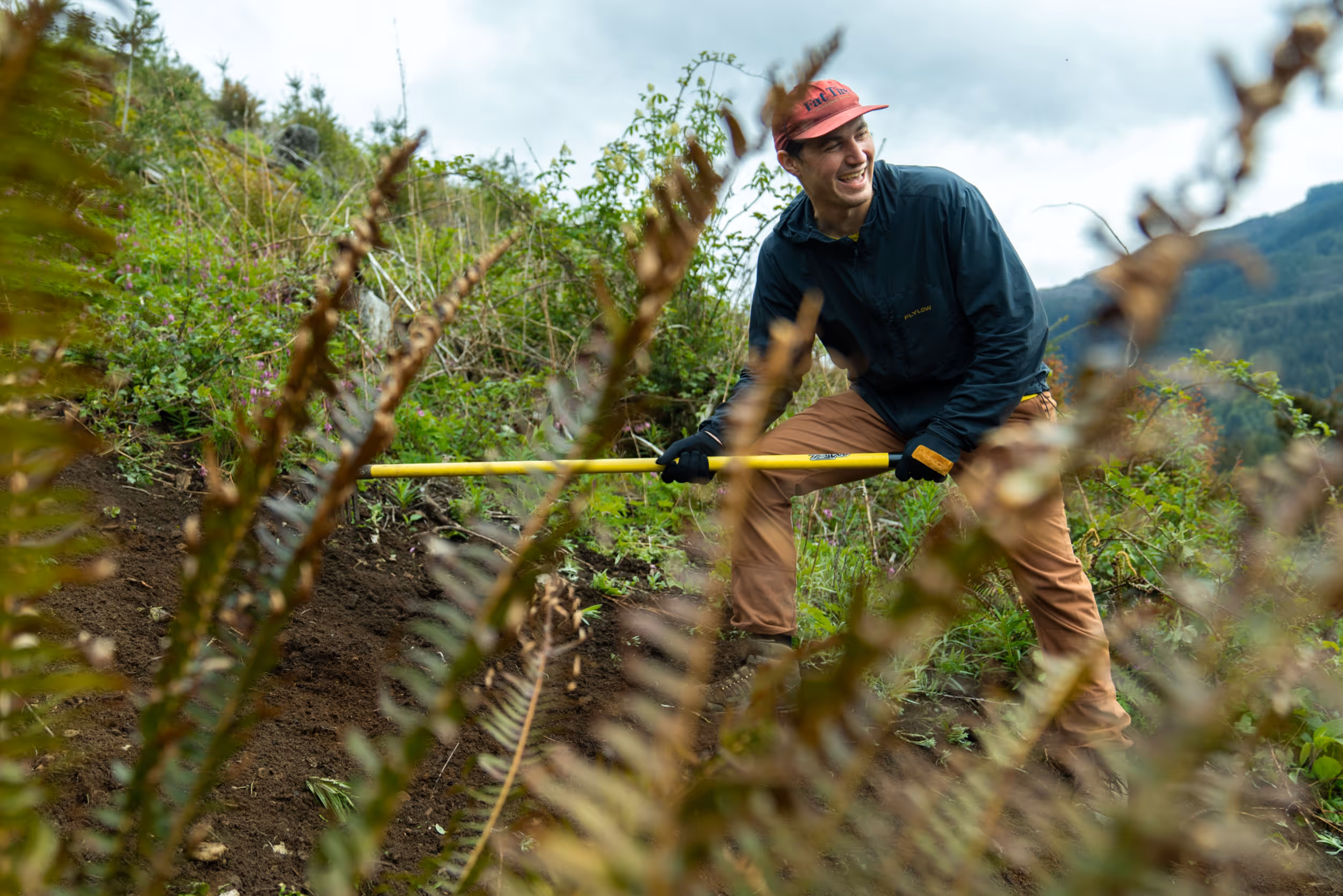 A trail worker getting some mountain bike trails all ready for riders 