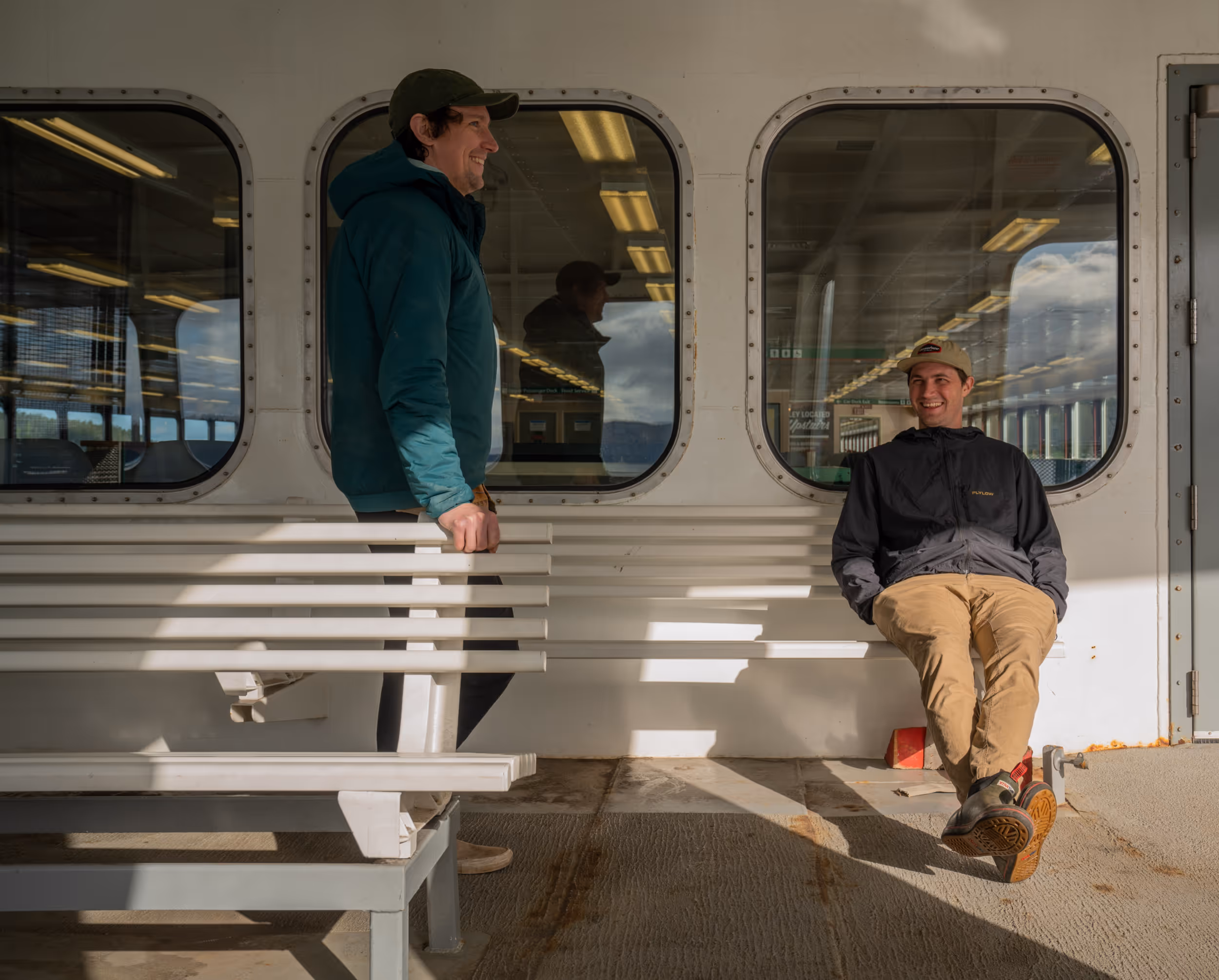 Some friends hanging out on a sunny bench during their ferry ride 